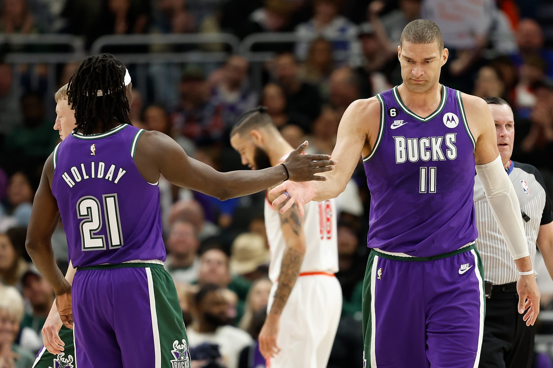 MILWAUKEE, WISCONSIN - FEBRUARY 24: Jrue Holiday #21 congratulates Brook Lopez #11 of the Milwaukee Bucks after scoring during the second half of the game against the Miami Heat at Fiserv Forum on February 24, 2023 in Milwaukee, Wisconsin. NOTE TO USER: User expressly acknowledges and agrees that, by downloading and or using this photograph, User is consenting to the terms and conditions of the Getty Images License Agreement. (Photo by John Fisher/Getty Images)