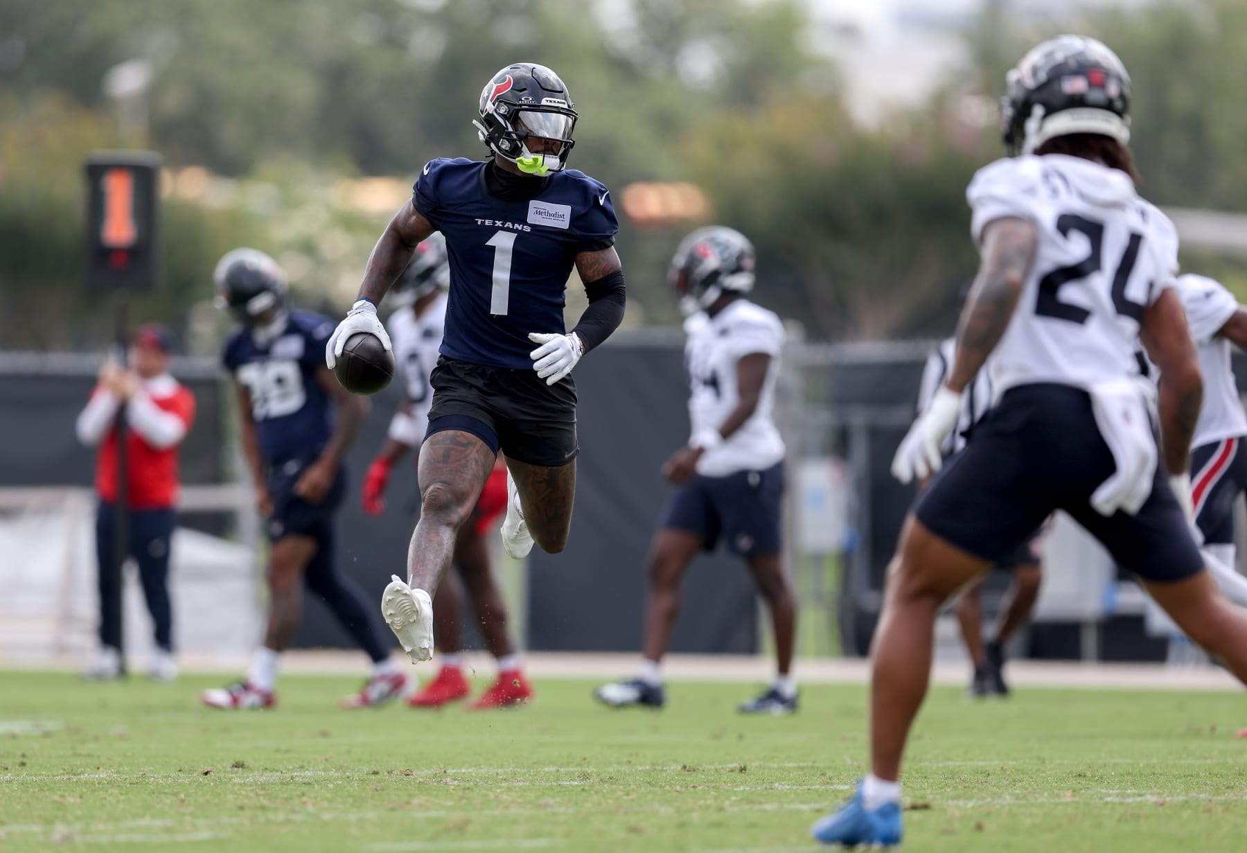HOUSTON, TEXAS - JUNE 04: Stefon Diggs #1 of the Houston Texans runs after a catch during Mandatory Minicamp at Houston Methodist Training Center on June 04, 2024 in Houston, Texas. (Photo by Tim Warner/Getty Images)