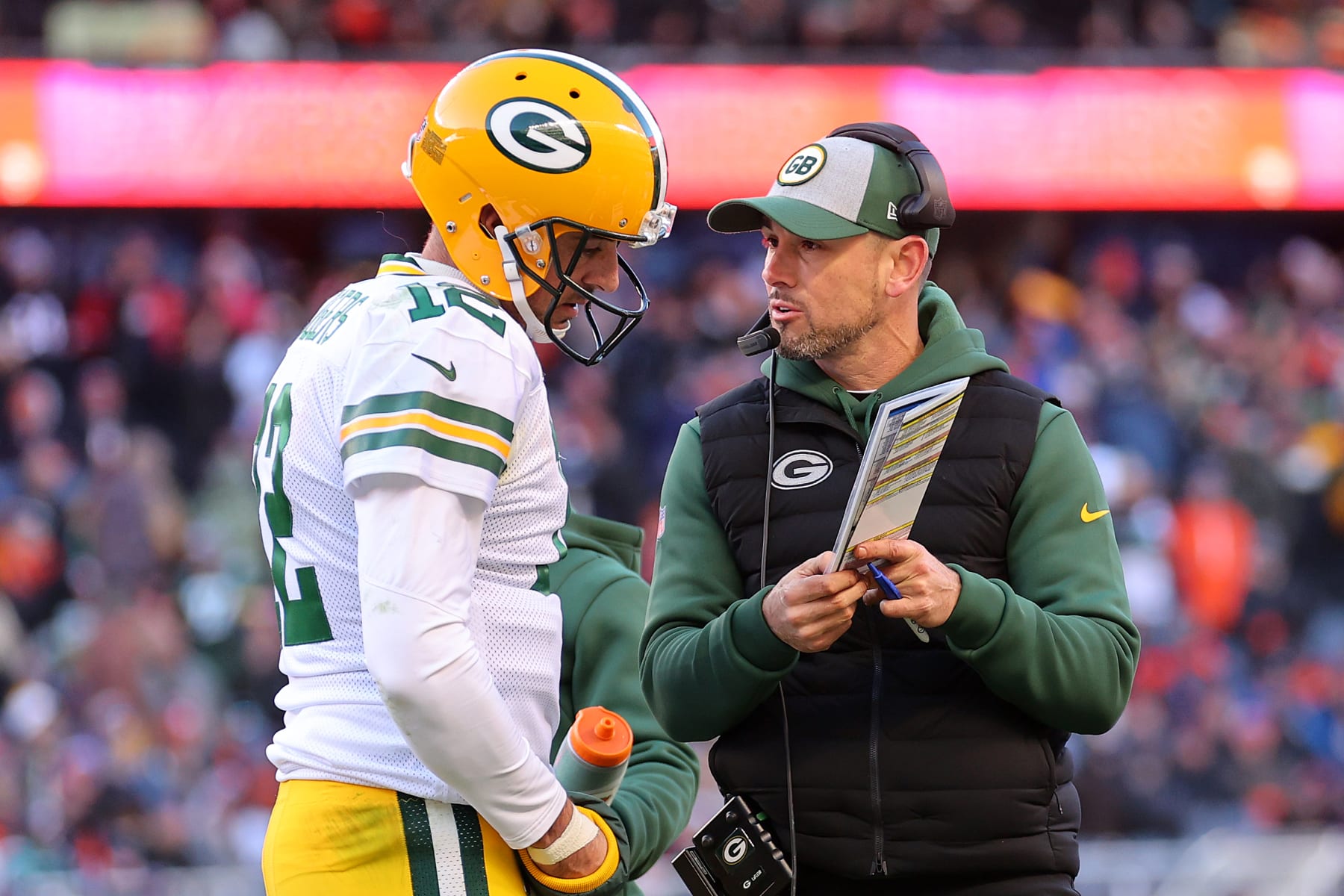 CHICAGO, ILLINOIS - DECEMBER 04: Aaron Rodgers #12 of the Green Bay Packers and head coach Matt LaFleur talk during the second half of the game against the Chicago Bears at Soldier Field on December 04, 2022 in Chicago, Illinois. (Photo by Michael Reaves/Getty Images)