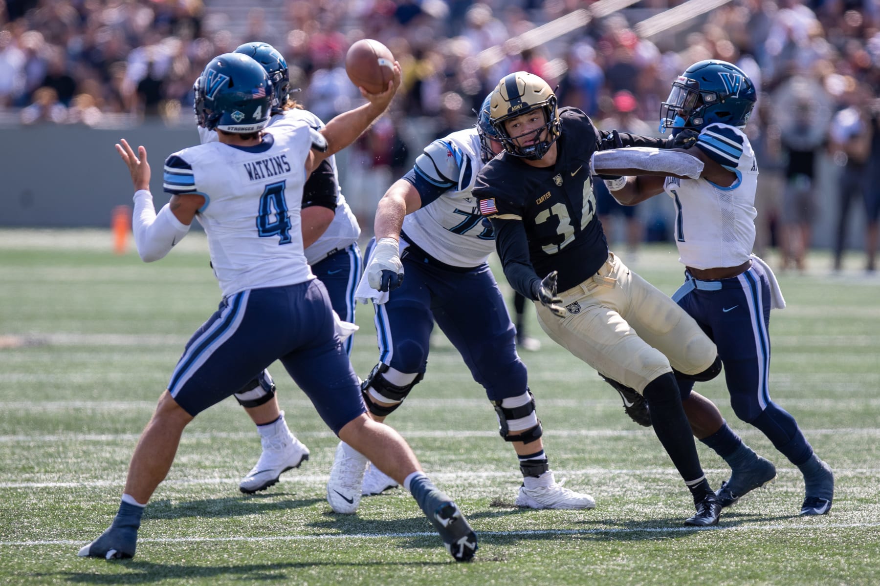 WEST POINT, NY - SEPTEMBER 17: Andre Carter II #34 of the Army Black Knights applies pressure as Connor Watkins #4 of the Villanova Wildcats thorws a  pass against the Army Black Knights at Michie Stadium on September 17, 2022 in West Point, New York. (Photo by Edward Diller/Getty Images)