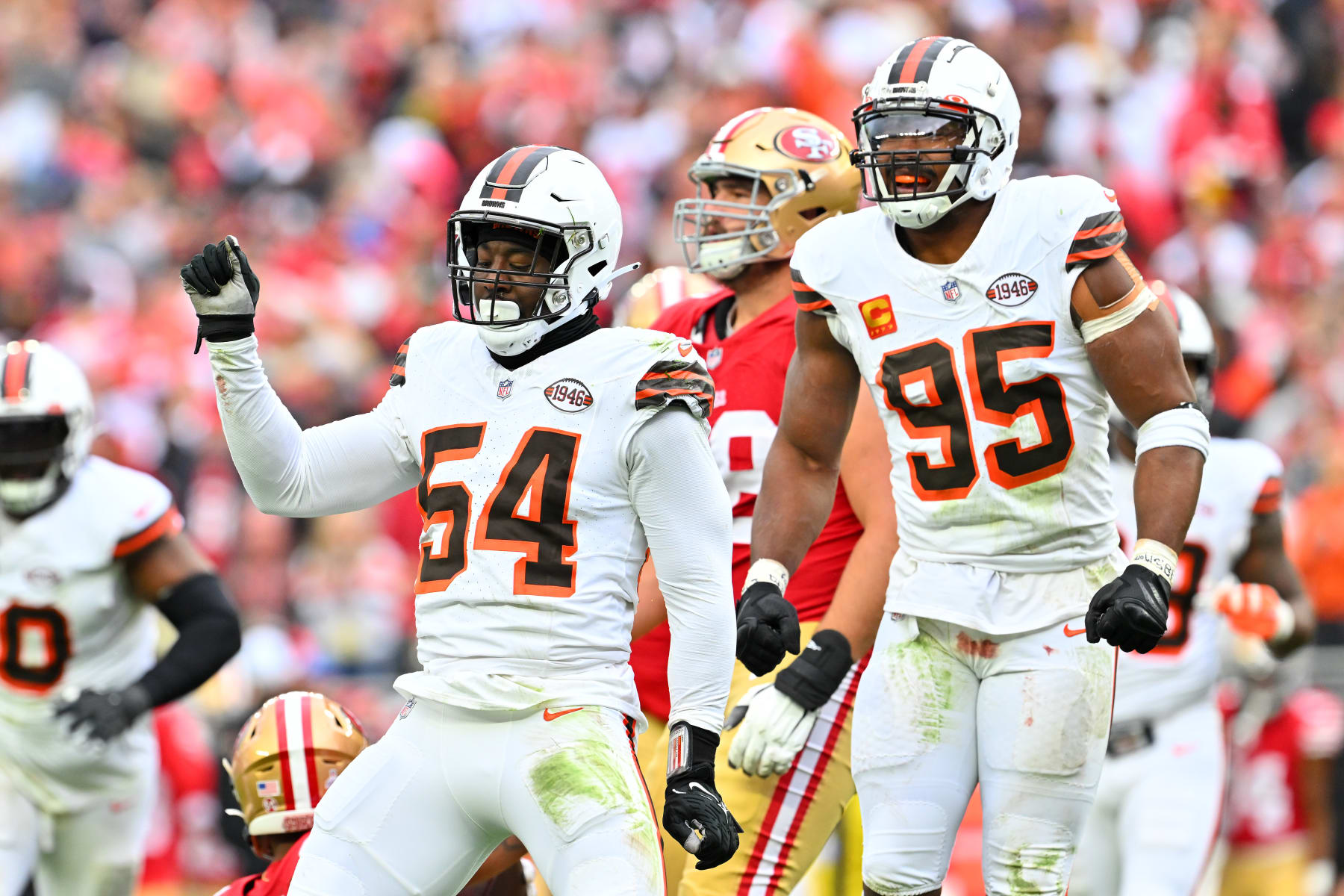 CLEVELAND, OHIO - OCTOBER 15: Ogbo Okoronkwo #54 of the Cleveland Browns and Myles Garrett #95 of the Cleveland Browns celebrate after a defensive play during the third quarter against the San Francisco 49ers at Cleveland Browns Stadium on October 15, 2023 in Cleveland, Ohio. (Photo by Jason Miller/Getty Images)