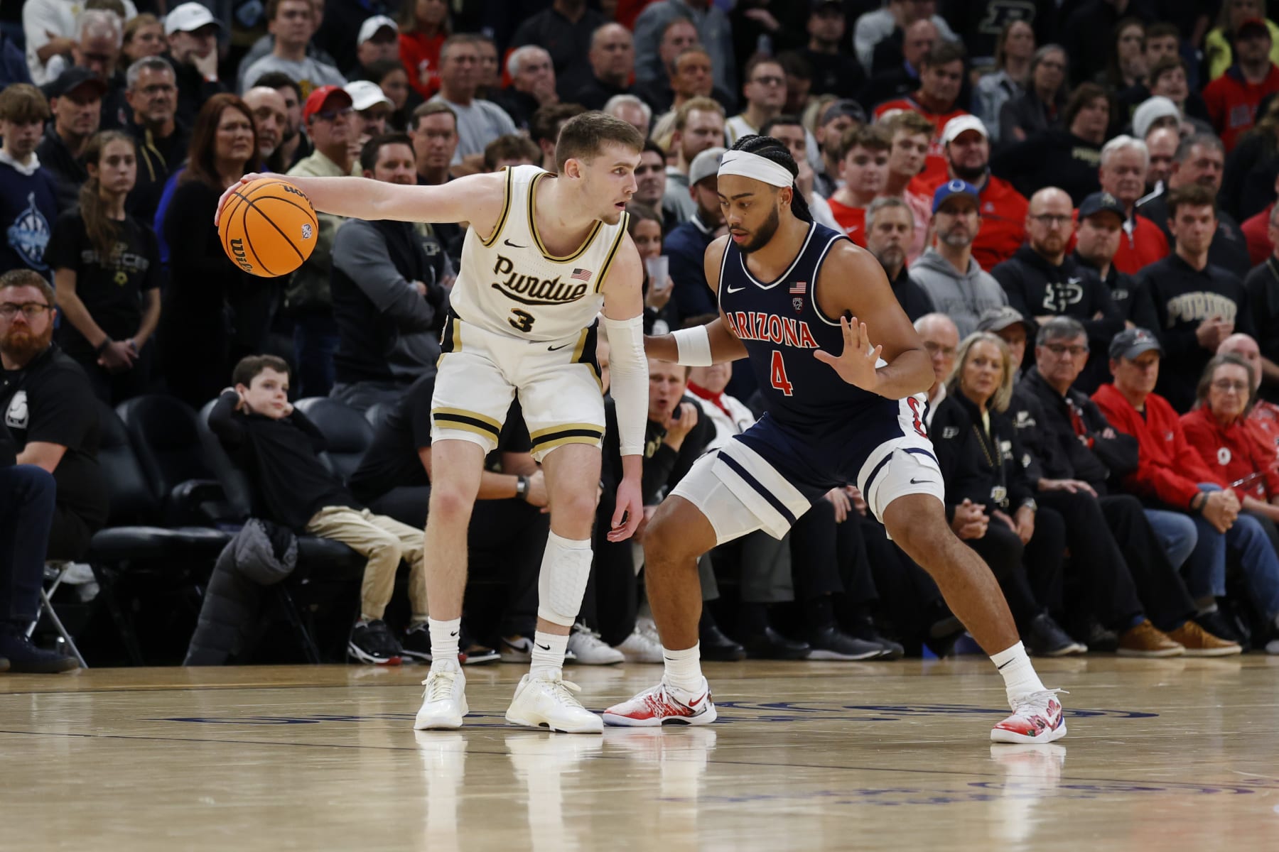 INDIANAPOLIS, IN - DECEMBER 16: Purdue Boilermakers guard Braden Smith (3) is guarded by Arizona Wildcats guard Kylan Boswell (4) during the 2023 Indy Classic on December 16, 2023, at Gainbridge Fieldhouse in Indianapolis, Indiana. (Photo by Brian Spurlock/Icon Sportswire via Getty Images)