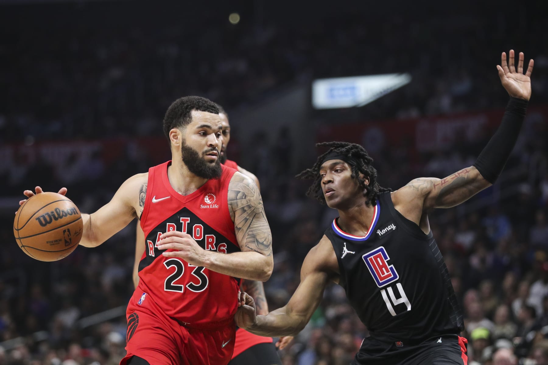 LOS ANGELES, CALIFORNIA - MARCH 16: Fred VanVleet #23 of the Toronto Raptors handles the ball defended by Terance Mann #14 of the LA Clippers in the first half at Crypto.com Arena on March 16, 2022 in Los Angeles, California. NOTE TO USER: User expressly acknowledges and agrees that, by downloading and or using this photograph, User is consenting to the terms and conditions of the Getty Images License Agreement. (Photo by Meg Oliphant/Getty Images)