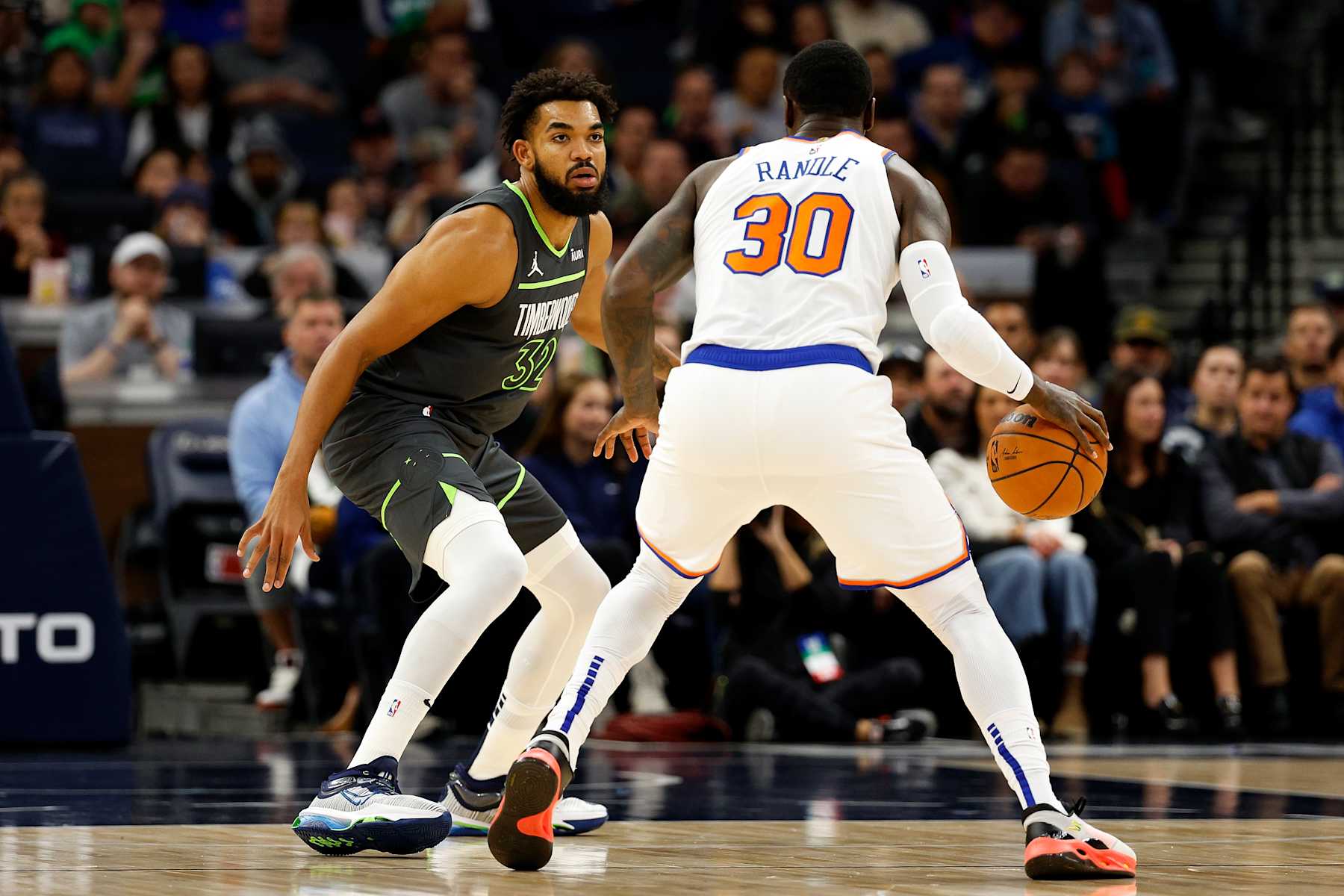 MINNEAPOLIS, MINNESOTA - NOVEMBER 20: Julius Randle #30 of the New York Knicks dribbles the ball while Karl-Anthony Towns #32 of the Minnesota Timberwolves defends in the first quarter at Target Center on November 20, 2023 in Minneapolis, Minnesota. The Timberwolves defeated the Knicks 117-100. NOTE TO USER: User expressly acknowledges and agrees that, by downloading and or using this photograph, User is consenting to the terms and conditions of the Getty Images License Agreement. (Photo by David Berding/Getty Images)