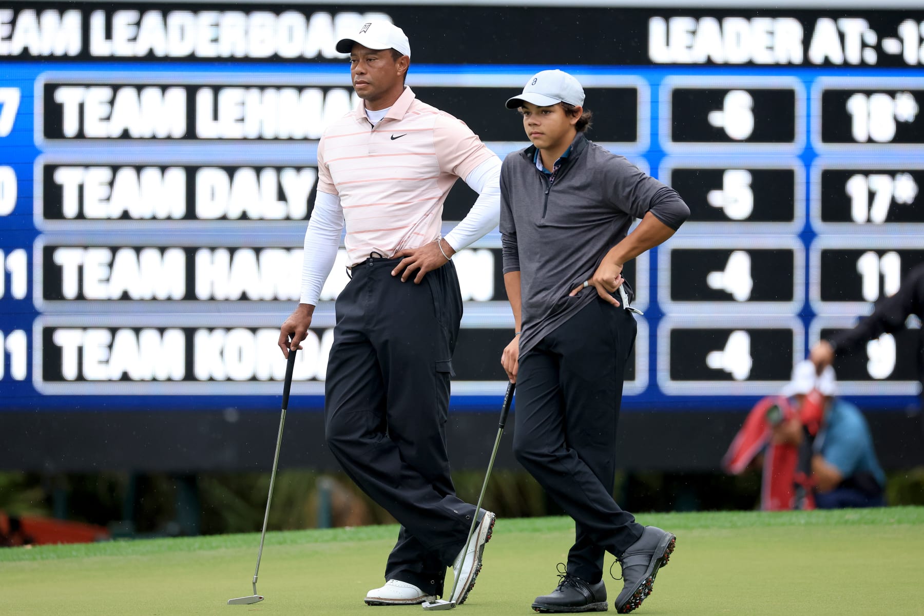 ORLANDO, FLORIDA - DECEMBER 16: Tiger Woods of The United States and his son Charlie Woods wait to putt on the ninth hole standing in a similar fashion during the first round of the PNC Championship at The Ritz-Carlton Golf Club on December 16, 2023 in Orlando, Florida. (Photo by David Cannon/Getty Images)