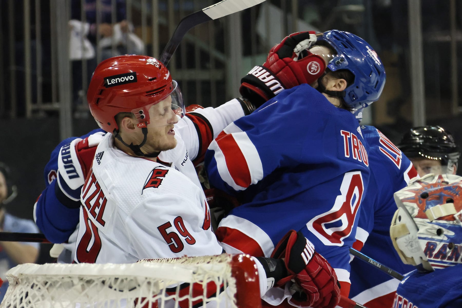 NEW YORK, NEW YORK - MAY 05: Jake Guentzel #59 of the Carolina Hurricanes gets the glove up on Jacob Trouba #8 of the New York Rangers in Game One of the Second Round of the 2024 Stanley Cup Playoffs at Madison Square Garden on May 05, 2024 in New York City.  (Photo by Bruce Bennett/Getty Images)