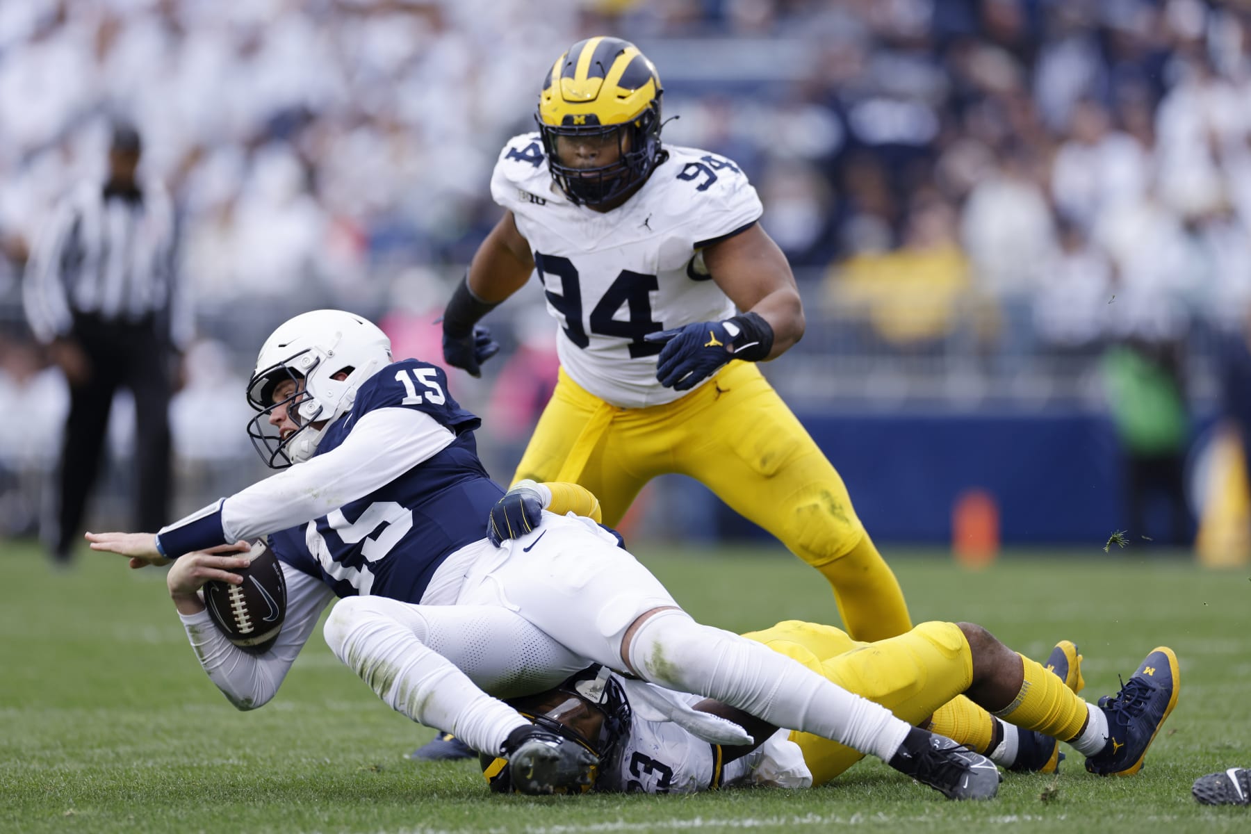 UNIVERSITY PARK, PA - NOVEMBER 11: Michigan Wolverines linebacker Michael Barrett (23) and defensive lineman Kris Jenkins (94) tackle Penn State Nittany Lions quarterback Drew Allar (15) during a college football game on November 11, 2023 at Beaver Stadium in University Park, Pennsylvania. (Photo by Joe Robbins/Icon Sportswire via Getty Images)