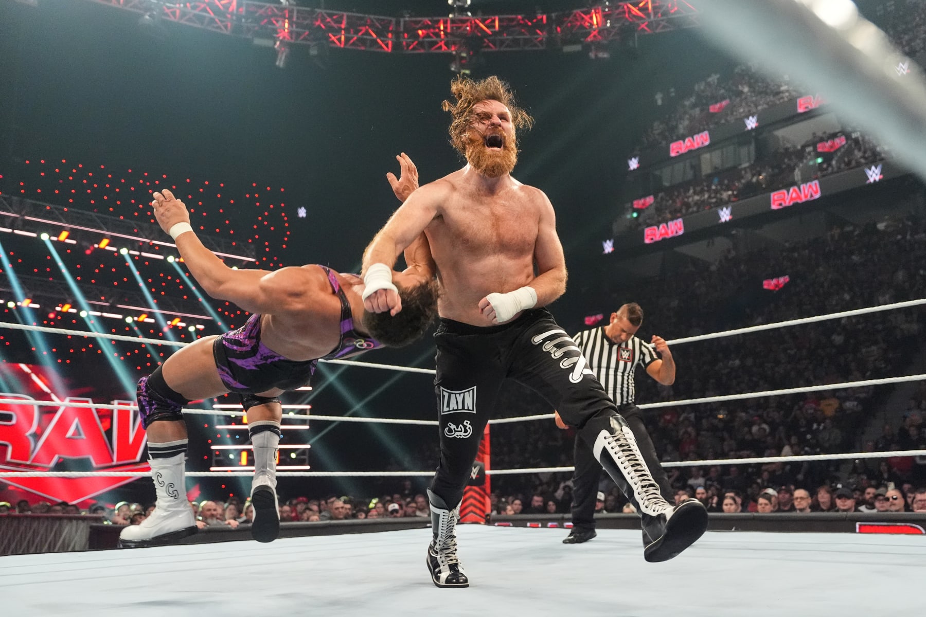 MONTREAL, CANADA - APRIL 15: Sami Zayn clotheslines Chad Gable during Monday Night RAW at the Bell Centre on April 15, 2024 in Montreal, Canada.  (Photo by WWE/Getty Images)