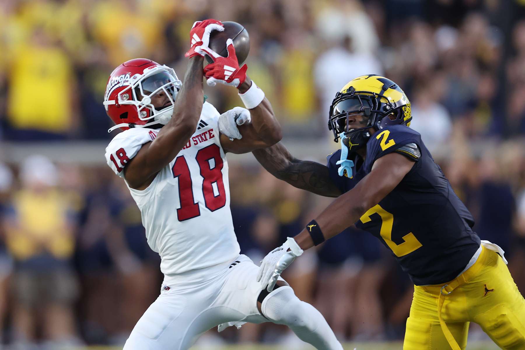 ANN ARBOR, MICHIGAN - AUGUST 31: Jalen Moss #18 of the Fresno State Bulldogs makes a first half catch next to Will Johnson #2 of the Michigan Wolverines at Michigan Stadium on August 31, 2024 in Ann Arbor, Michigan.  (Photo by Gregory Shamus/Getty Images)