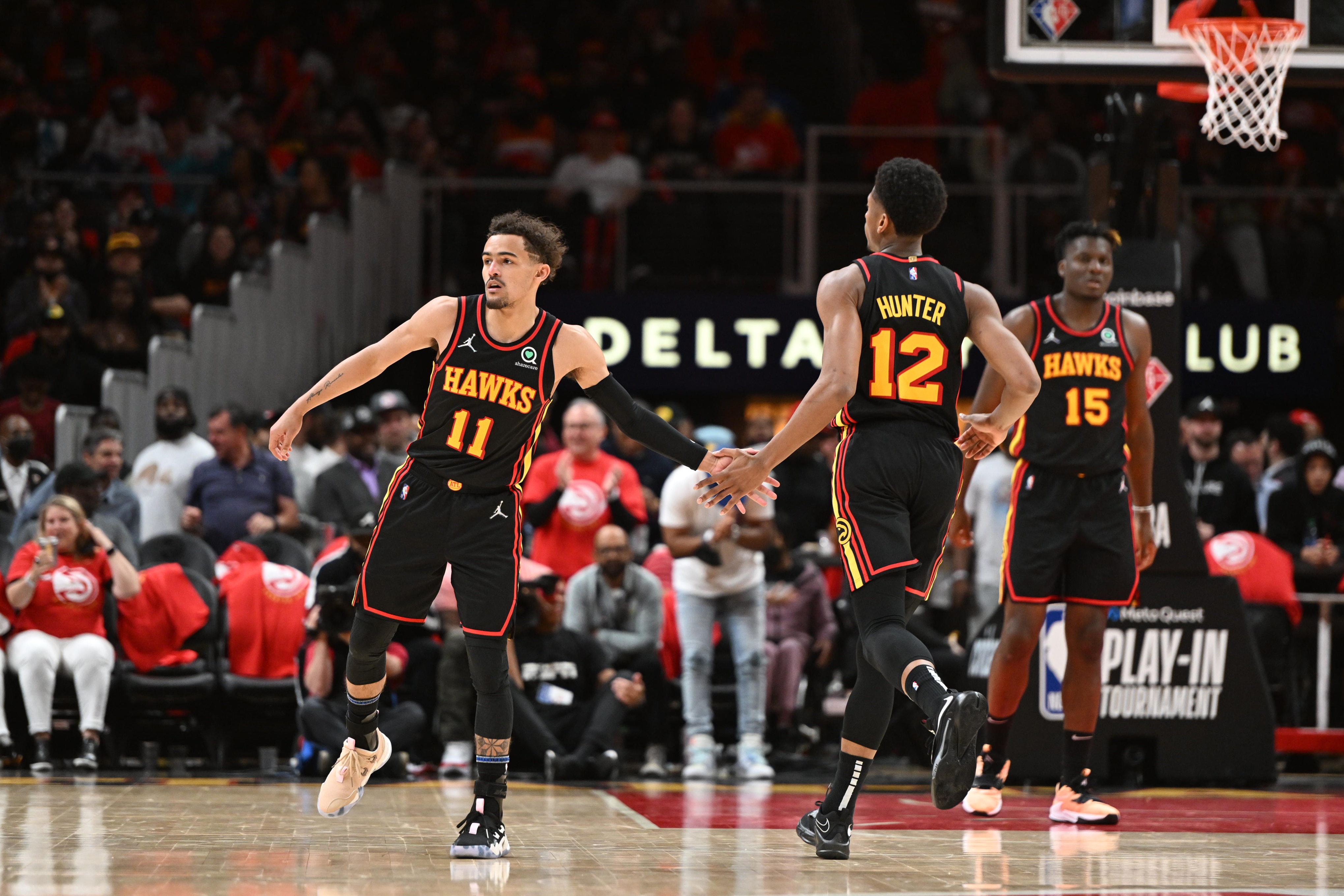 ATLANTA, GA - APRIL 13: Trae Young #11 and De'Andre Hunter #12 of the Atlanta Hawks embrace during the 2022 Play-In Tournament on April 13, 2022 at State Farm Arena in Atlanta, Georgia.  NOTE TO USER: User expressly acknowledges and agrees that, by downloading and/or using this Photograph, user is consenting to the terms and conditions of the Getty Images License Agreement. Mandatory Copyright Notice: Copyright 2022 NBAE (Photo by Adam Hagy/NBAE via Getty Images)