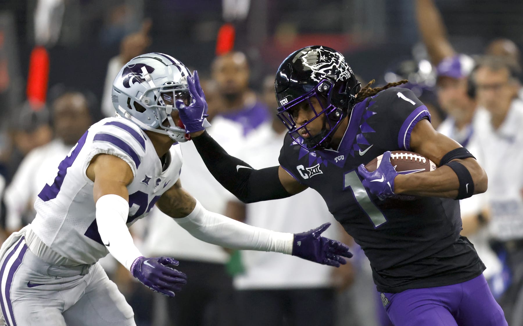 ARLINGTON, TX - DECEMBER 3: Quentin Johnston #1 of the TCU Horned Frogs stiff arms Julius Brents #23 of the Kansas State Wildcats in the first half of the Big 12 Football Championship at AT&T Stadium on December 3, 2022 in Arlington, Texas.  (Photo by Ron Jenkins/Getty Images)