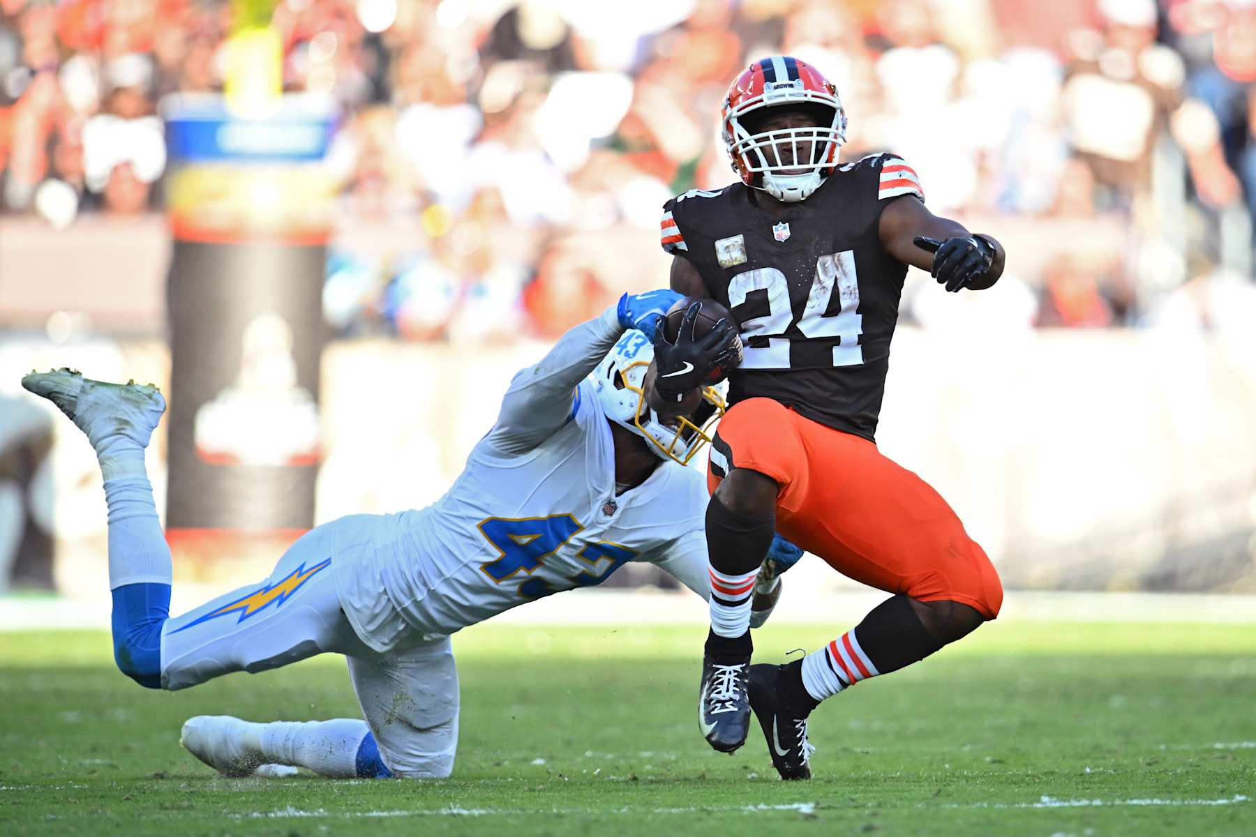CLEVELAND, OHIO - NOVEMBER 03: Troy Dye #43 of the Los Angeles Chargers tackles Nick Chubb #24 of the Cleveland Browns in the fourth quarter of a game at Huntington Bank Field on November 03, 2024 in Cleveland, Ohio. (Photo by Jason Miller/Getty Images)