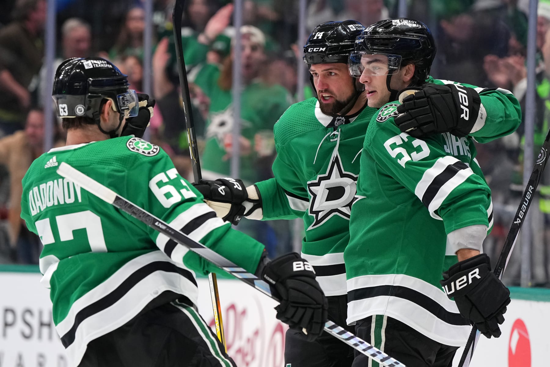 DALLAS, TEXAS - JANUARY 02: Jamie Benn #14 (C) of the Dallas Stars celebrates his first period goal against the Montreal Canadiens with Evgenii Dadonov #63 and Wyatt Johnston #53 at American Airlines Center on January 02, 2024 in Dallas, Texas. (Photo by Sam Hodde/Getty Images)