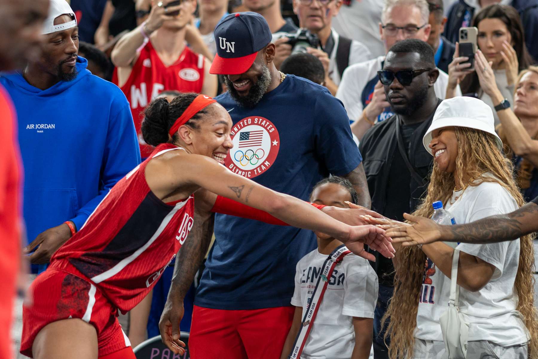 PARIS, FRANCE: AUGUST 11: LeBron James, Savannah James, and daughter Zhuri Nova congratulate A'Ja Wilson #9 of Team United States on the sideline after the team's gold medal win during the United States of America v France, Women's Basketball Gold Medal Game at the Bercy Arena during the Paris 2024 Summer Olympic Games on August 11th, 2024 in Paris, France. (Photo by Tim Clayton/Corbis via Getty Images)