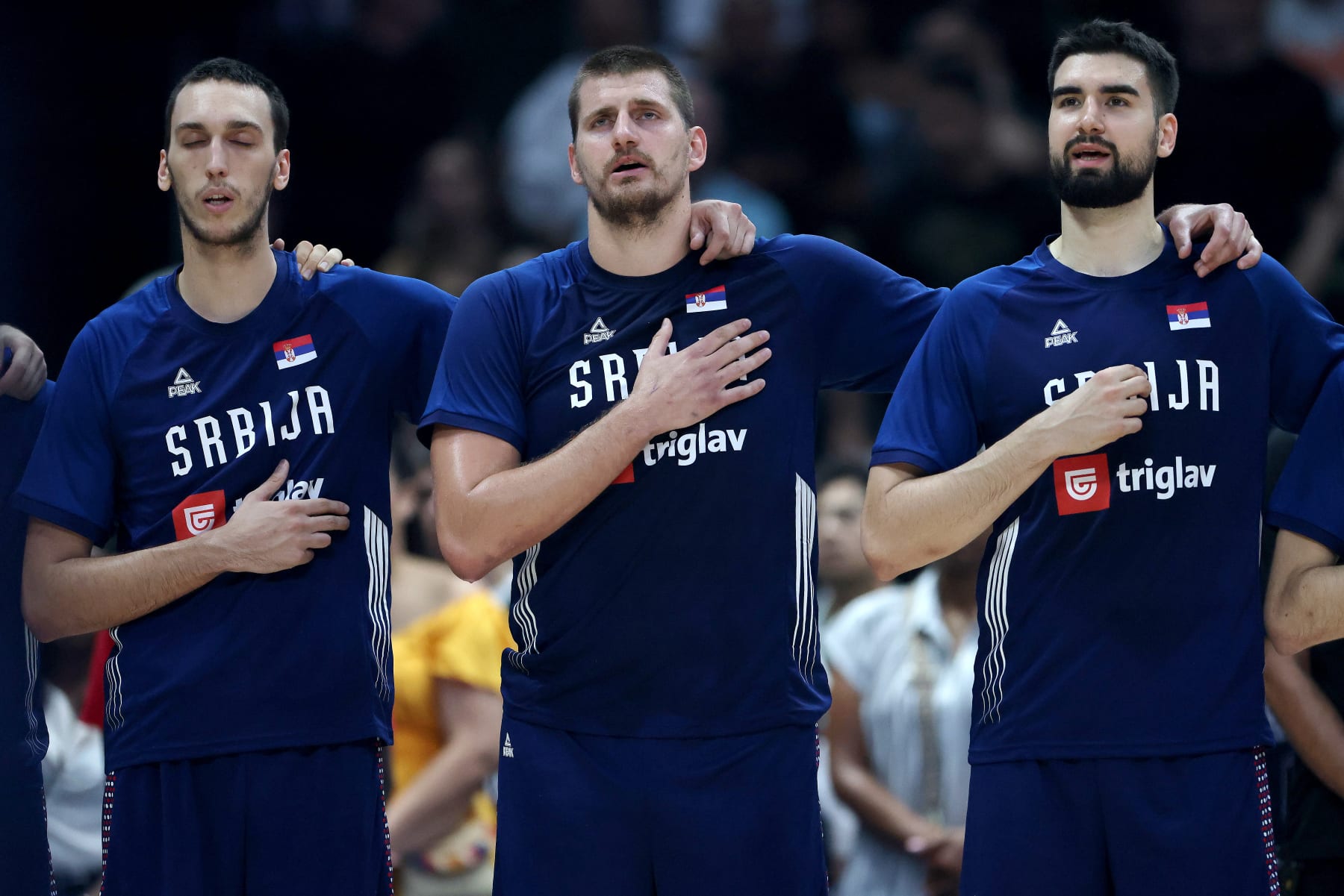 ABU DHABI, UNITED ARAB EMIRATES - JULY 17: Nikola Jokic (C) #15 of Serbia stands with teammates during their national anthem during an exhibition game between the United States and Serbia ahead of the Paris Olympic Games at Etihad Arena on July 17, 2024 in Abu Dhabi, United Arab Emirates. (Photo by Christopher Pike/Getty Images)
