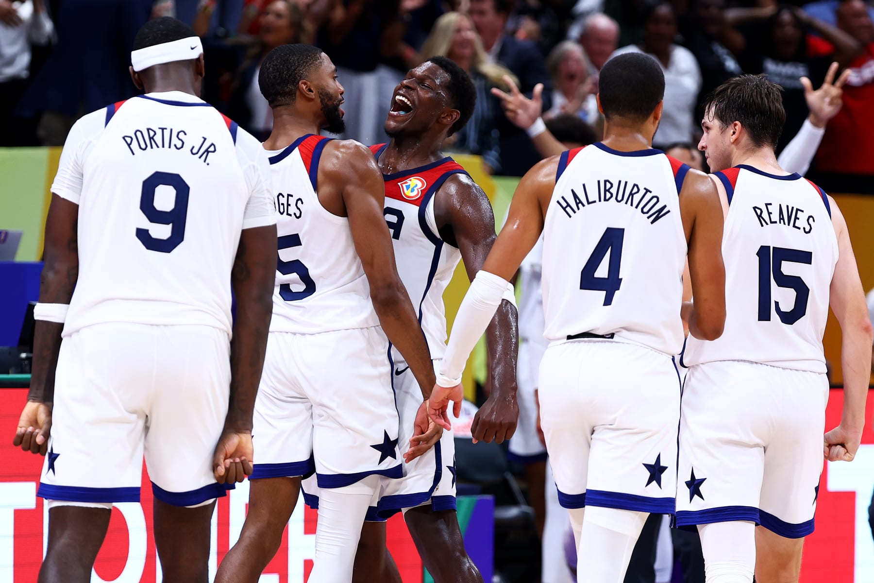 MANILA, PHILIPPINES - SEPTEMBER 10: Mikal Bridges #5 (2L) of the United States celebrates with Bobby Portis #9 (L), Anthony Edwards #10 (3L), Tyrese Haliburton #4 (4L) and Austin Reaves #15 after scoring a three-pointer to tie the game late in the fourth quarter during the FIBA Basketball World Cup 3rd Place game against Canada at Mall of Asia Arena on September 10, 2023 in Manila, Philippines. (Photo by Yong Teck Lim/Getty Images)