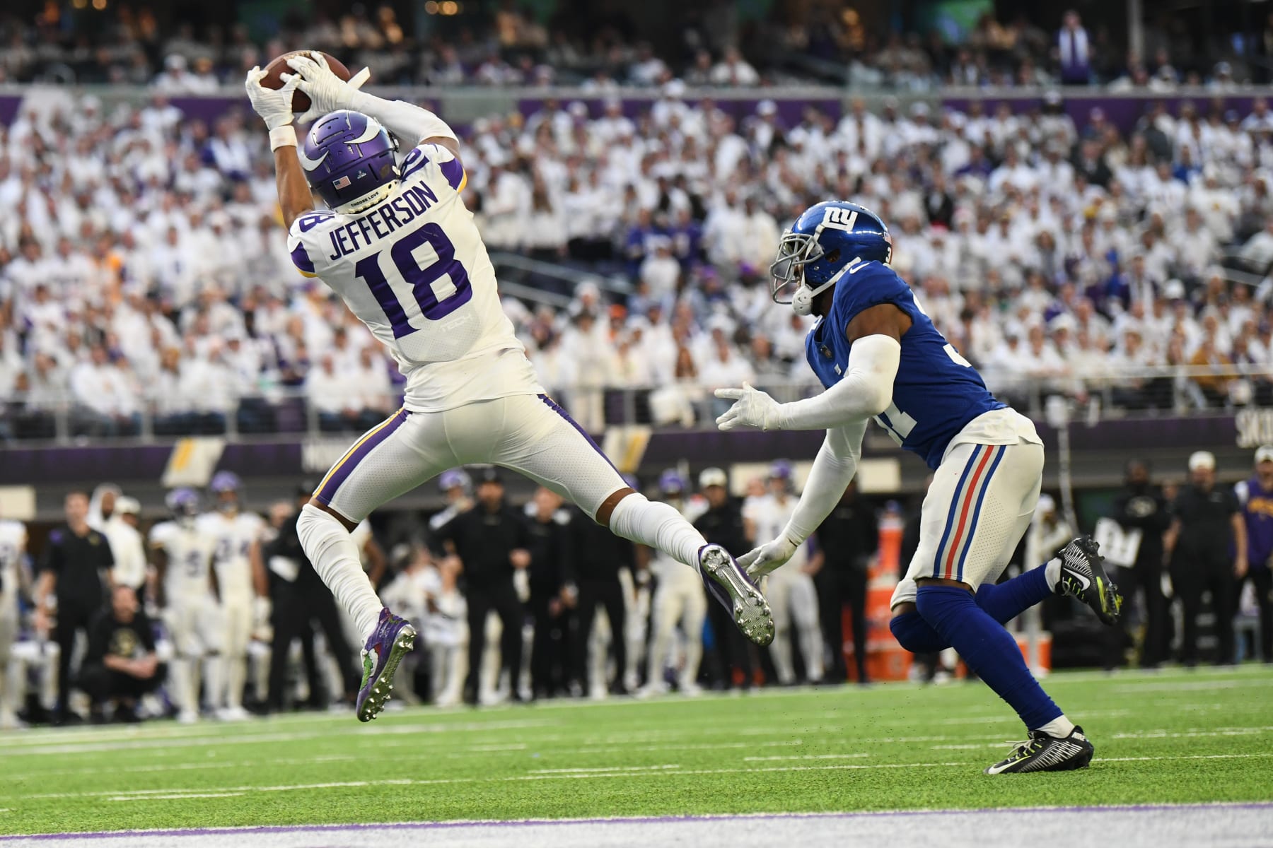 MINNEAPOLIS, MINNESOTA - DECEMBER 24: Justin Jefferson #18 of the Minnesota Vikings catches a touchdown pass against the New York Giants during the fourth quarter of the game at U.S. Bank Stadium on December 24, 2022 in Minneapolis, Minnesota. (Photo by Stephen Maturen/Getty Images)