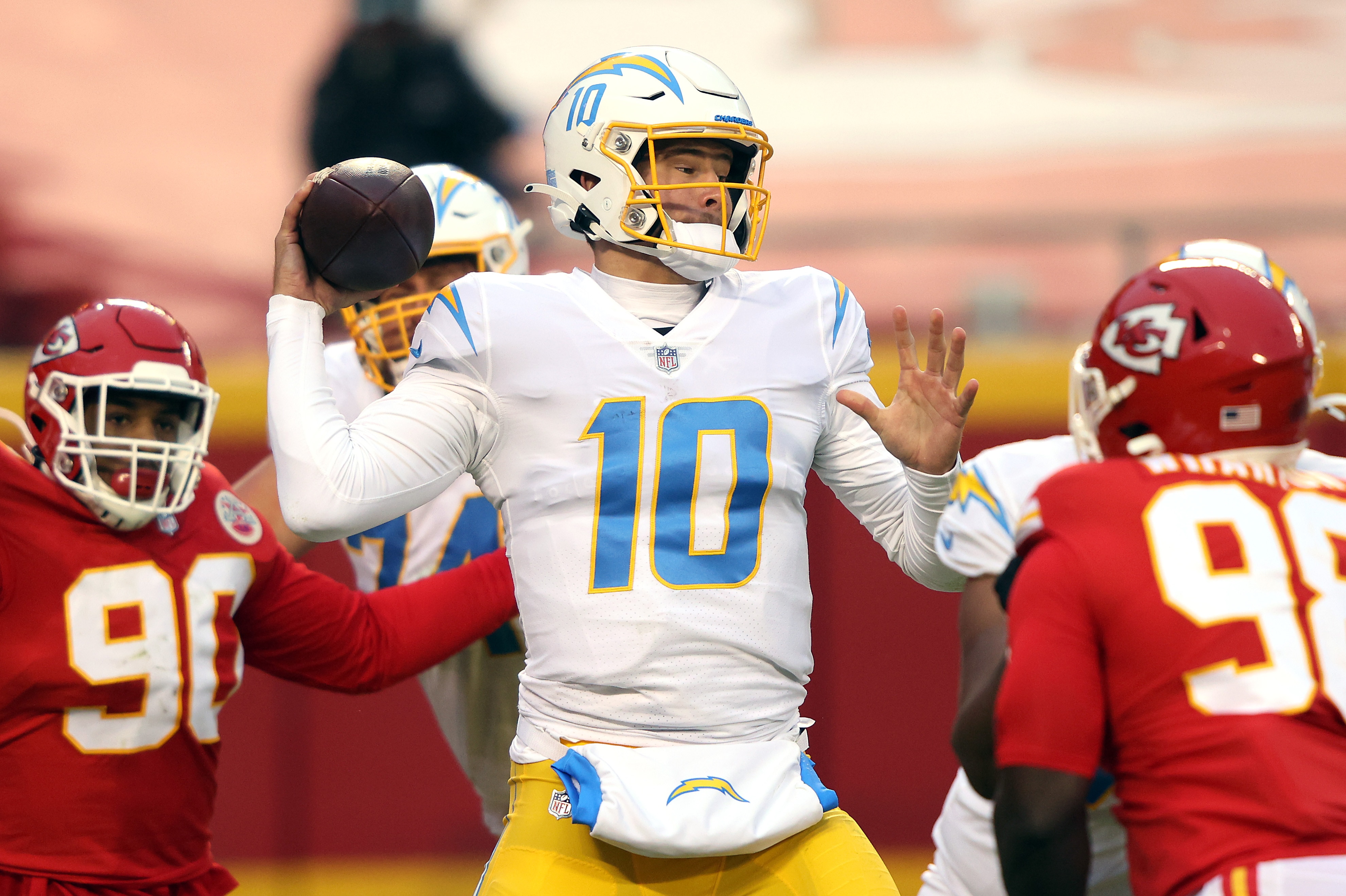 KANSAS CITY, MISSOURI - JANUARY 03:  Quarterback Justin Herbert #10 of the Los Angeles Chargers passes during the game against the Kansas City Chiefs at Arrowhead Stadium on January 03, 2021 in Kansas City, Missouri. (Photo by Jamie Squire/Getty Images)