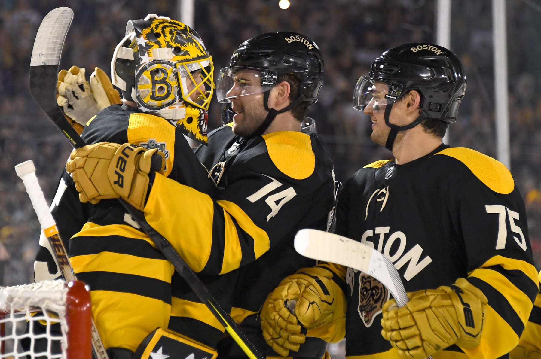 BOSTON, MASSACHUSETTS - JANUARY 02: Linus Ullmark #35 and Jake DeBrusk #74 of the Boston Bruins celebrate after the 2023 Discover NHL Winter Classic game between the Pittsburgh Penguins and the Boston Bruins at Fenway Park on January 02, 2023 in Boston, Massachusetts. The Bruins defeated the Penguins 2-1. (Photo by Joe Sargent/NHLI via Getty Images)