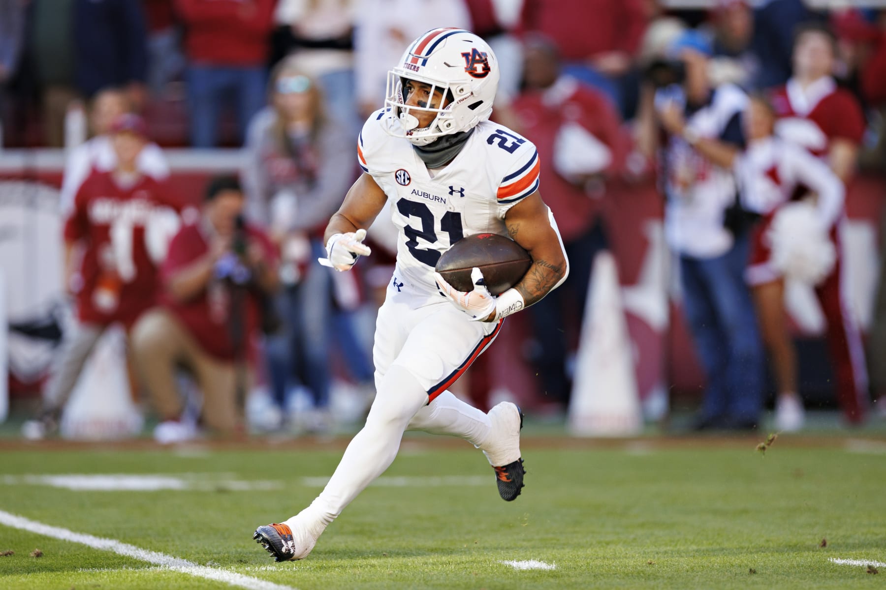 FAYETTEVILLE, ARKANSAS - NOVEMBER 11: Brian Battie #21 of the Auburn Tigers runs the ball during the game against the Arkansas Razorbacks at Donald W. Reynolds Razorback Stadium on November 11, 2023 in Fayetteville, Arkansas. The Tigers defeated the Razorbacks 48-10.  (Photo by Wesley Hitt/Getty Images)