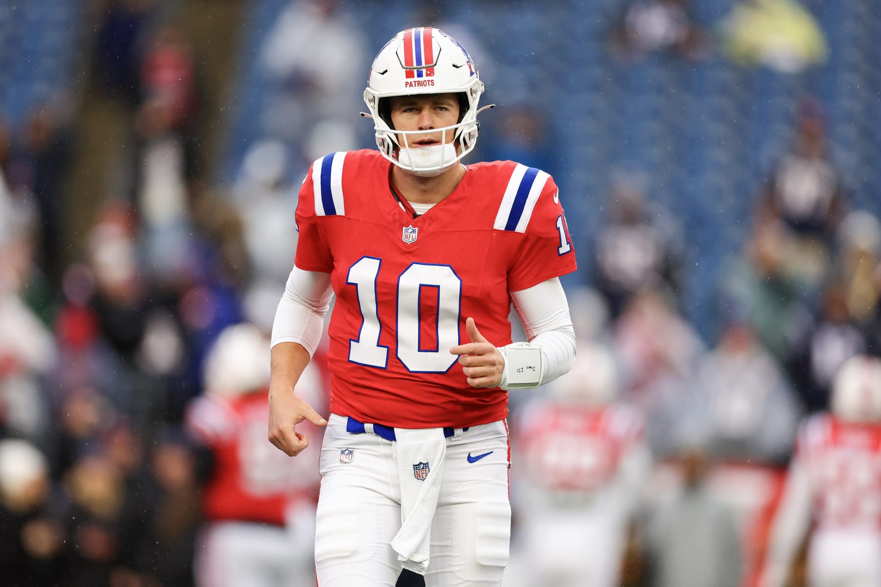 FOXBOROUGH, MASSACHUSETTS - DECEMBER 03: Mac Jones #10 of the New England Patriots jogs across the field before the game against the Los Angeles Chargers at Gillette Stadium on December 03, 2023 in Foxborough, Massachusetts. (Photo by Maddie Meyer/Getty Images)
