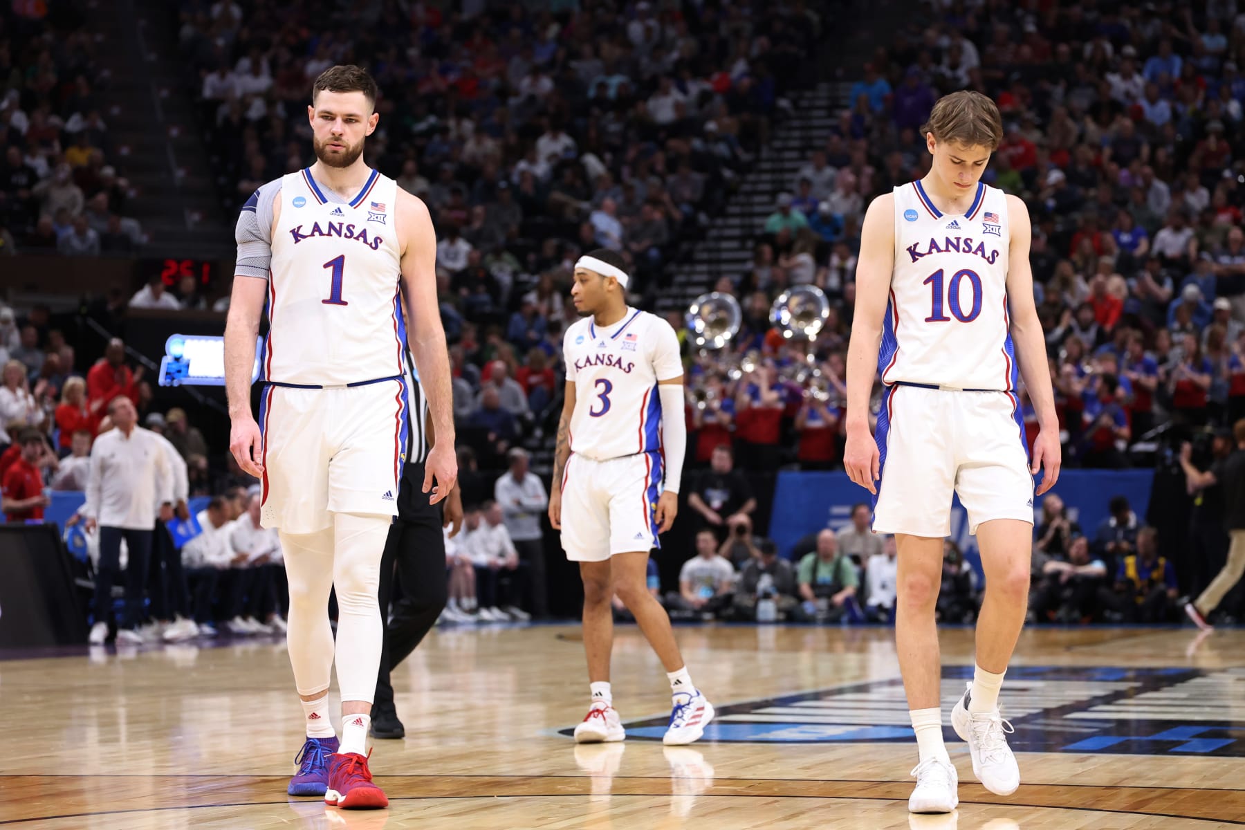 SALT LAKE CITY, UTAH - MARCH 23: (L-R) Hunter Dickinson #1, Dajuan Harris Jr. #3 and Johnny Furphy #10 of the Kansas Jayhawks react during the second half in the second round of the NCAA Men's Basketball Tournament at Delta Center on March 23, 2024 in Salt Lake City, Utah. (Photo by Christian Petersen/Getty Images)