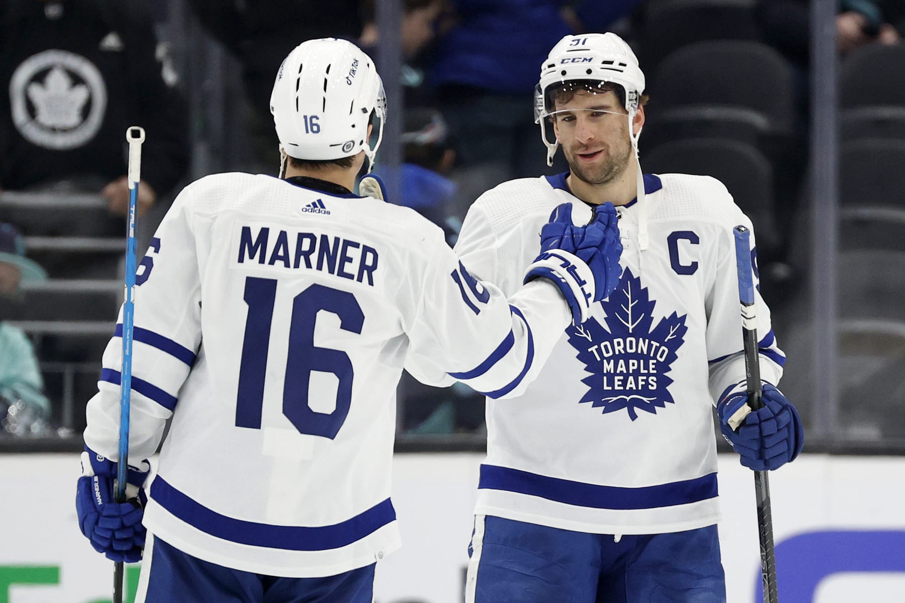 SEATTLE, WASHINGTON - FEBRUARY 26: Mitchell Marner #16 and John Tavares #91 of the Toronto Maple Leafs celebrate their 5-1 win against the Seattle Kraken at Climate Pledge Arena on February 26, 2023 in Seattle, Washington. (Photo by Steph Chambers/Getty Images)