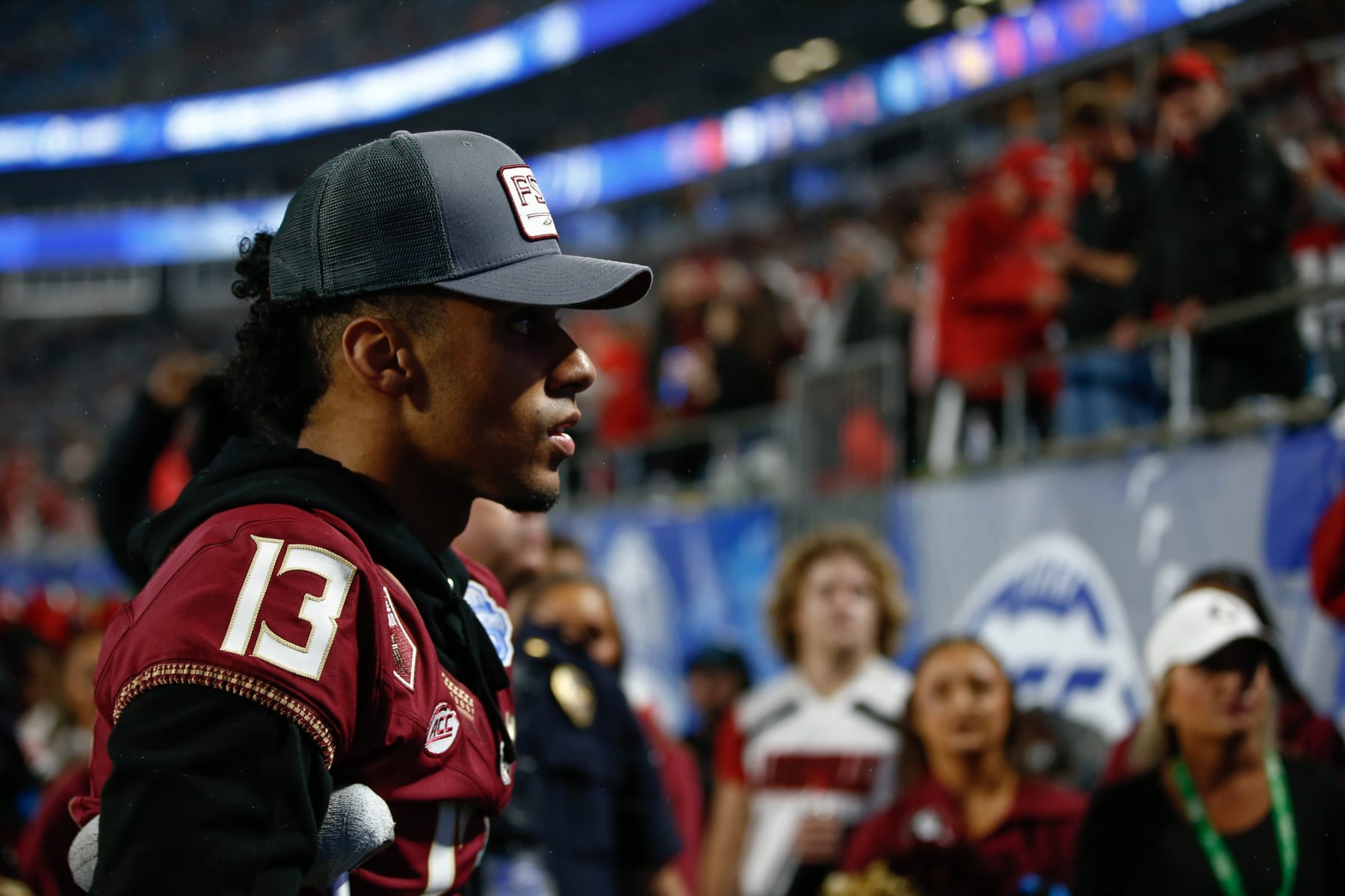 CHARLOTTE, NORTH CAROLINA - DECEMBER 2: Jordan Travis #13 of the Florida State Seminoles walks off the field after the first half against the Louisville Cardinals during the ACC Championship at Bank of America Stadium on December 2, 2023 in Charlotte, North Carolina. (Photo by Isaiah Vazquez/Getty Images)