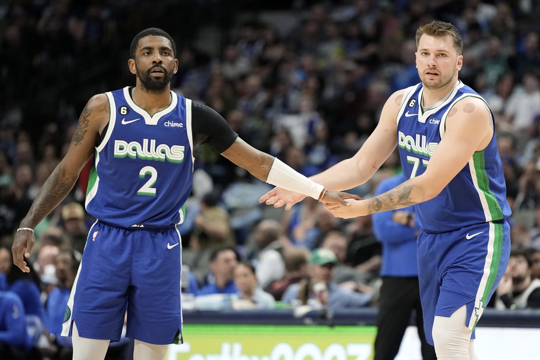 DALLAS, TEXAS - MARCH 24: Kyrie Irving #2 of the Dallas Mavericks congratulates Luka Doncic #77 during the first half against the Charlotte Hornets at American Airlines Center on March 24, 2023 in Dallas, Texas. NOTE TO USER: User expressly acknowledges and agrees that, by downloading and/or using this Photograph, user is consenting to the terms and conditions of the Getty Images License Agreement. (Photo by Sam Hodde/Getty Images)