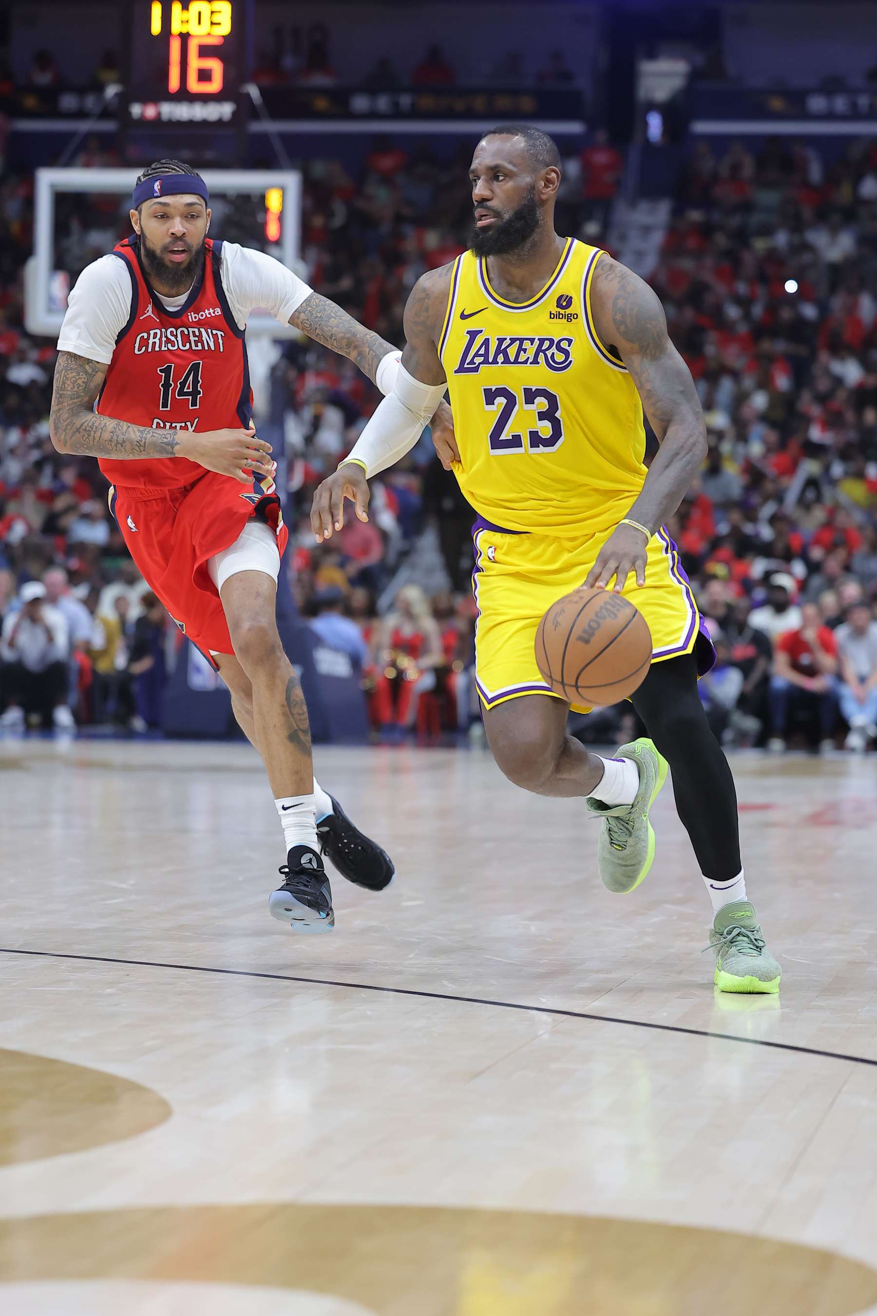 NEW ORLEANS, LOUISIANA - APRIL 16: LeBron James #23 of the Los Angeles Lakers drives against Brandon Ingram #14 of the New Orleans Pelicans during a play-in tournament game at the Smoothie King Center on April 16, 2024 in New Orleans, Louisiana. NOTE TO USER: User expressly acknowledges and agrees that, by downloading and or using this Photograph, user is consenting to the terms and conditions of the Getty Images License Agreement. (Photo by Jonathan Bachman/Getty Images)