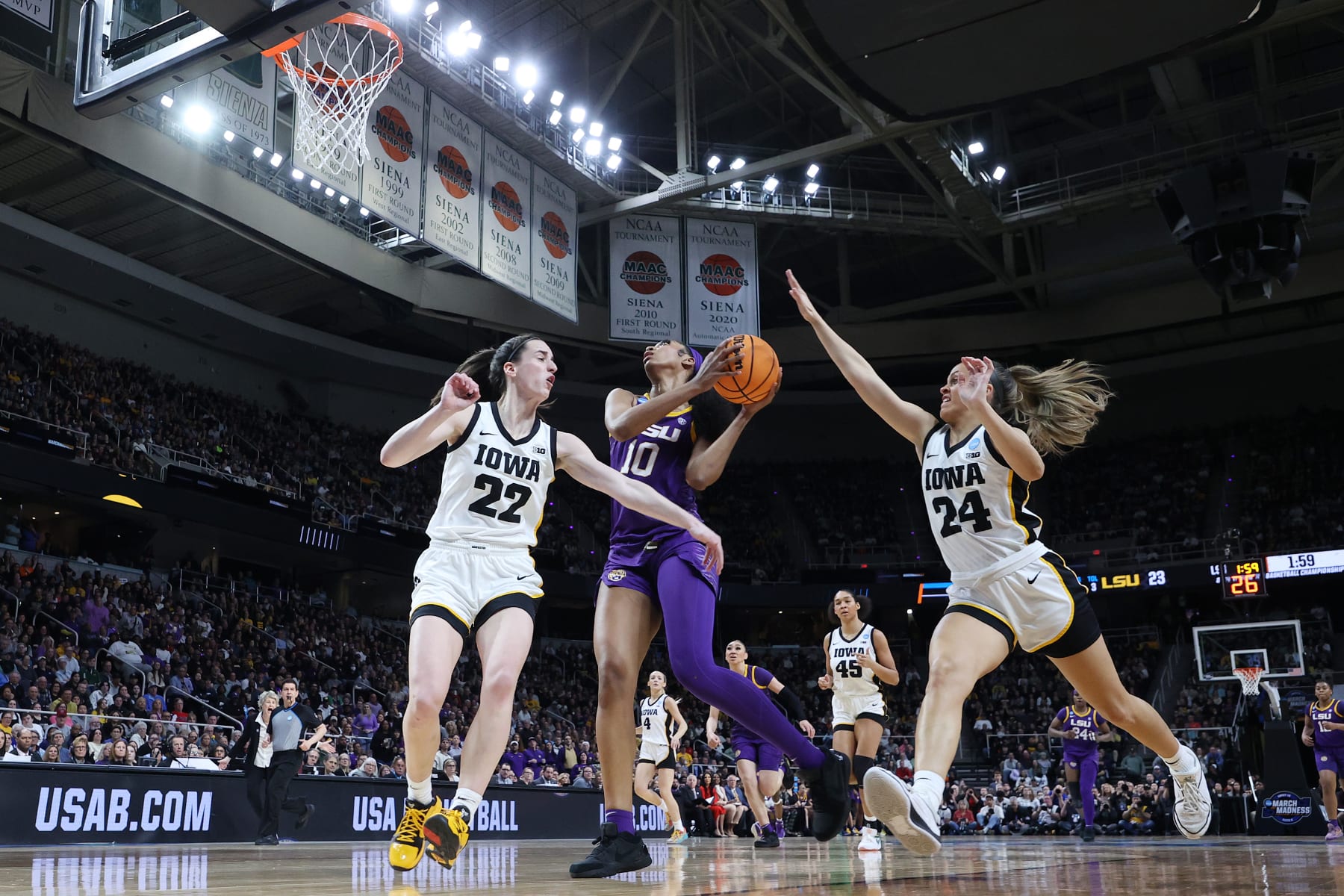ALBANY, NEW YORK - APRIL 01: Angel Reese #10 of the LSU Tigers shoots the ball over Caitlin Clark #22 and Gabbie Marshall #24 of the Iowa Hawkeyesduring the first half in the Elite 8 round of the NCAA Women's Basketball Tournament at MVP Arena on April 01, 2024 in Albany, New York. (Photo by Andy Lyons/Getty Images)