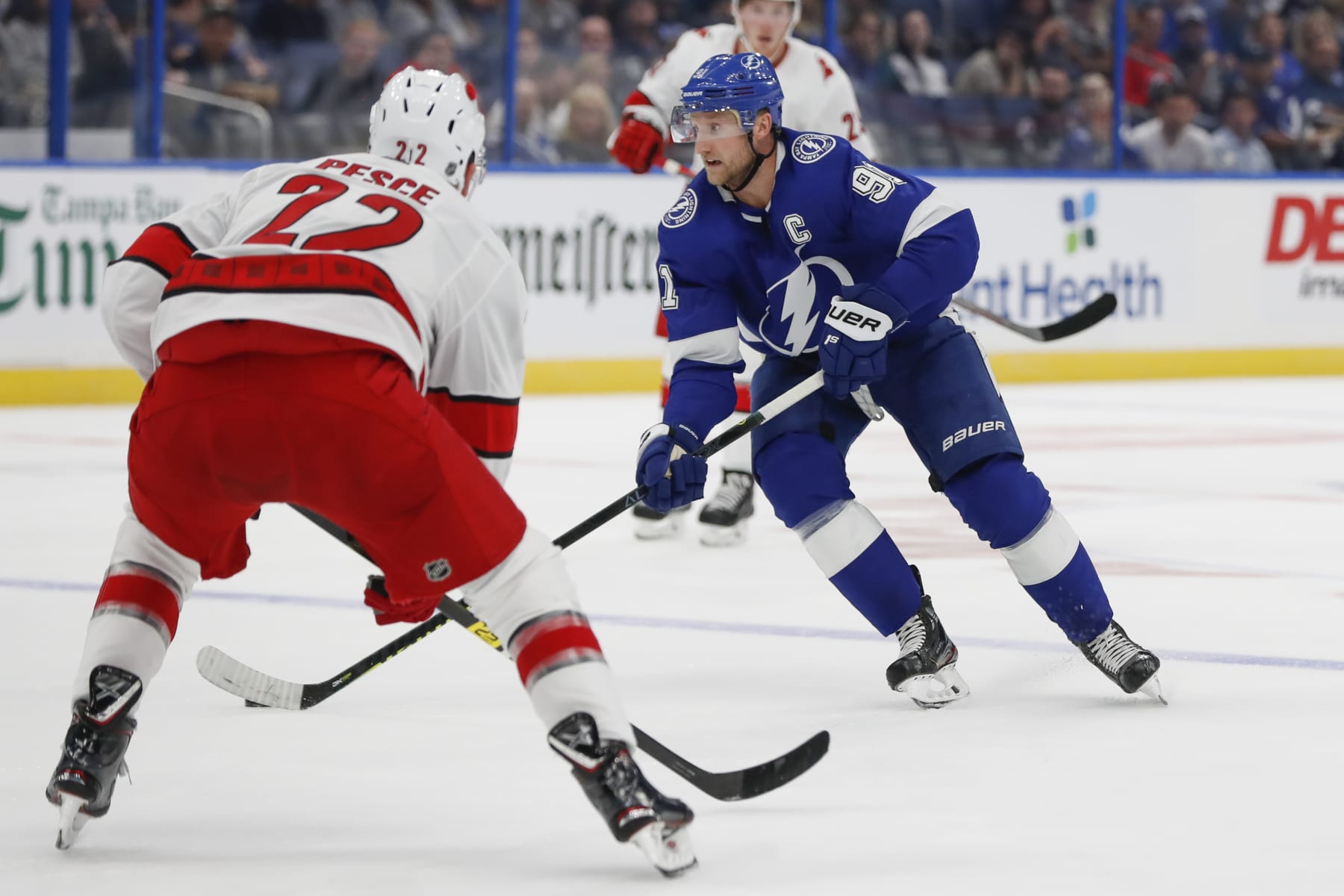 TAMPA, FL - SEPTEMBER 17: Tampa Bay Lightning center Steven Stamkos (91) is defended by Carolina Hurricanes defenseman Brett Pesce (22) during the NHL Preseason game between the Carolina Hurricanes and Tampa Bay Lightning on September 17, 2019 at Amalie Arena in Tampa, FL. (Photo by Mark LoMoglio/Icon Sportswire via Getty Images)