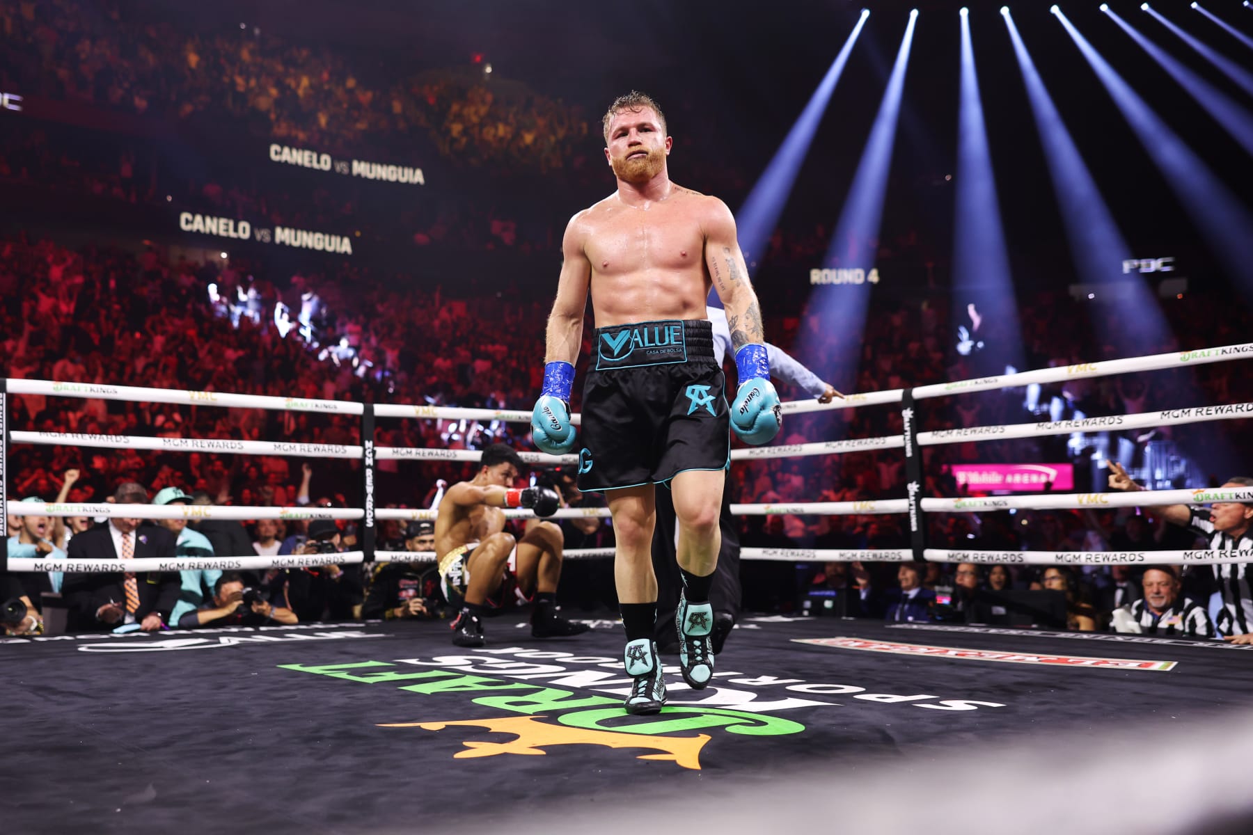 LAS VEGAS, NEVADA - MAY 04: Canelo Alvarez of Mexico (R) knocks down Jaime Munguia (L) during their super middleweight title fight at T-Mobile Arena on May 04, 2024 in Las Vegas, Nevada. (Photo by Cris Esqueda/Golden Boy/Getty Images)