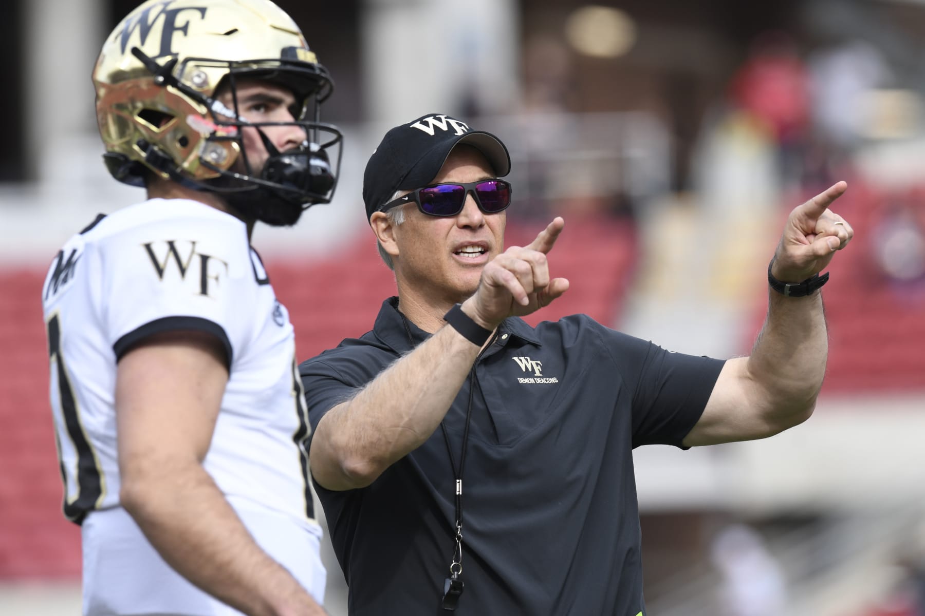 LOUISVILLE, KY - OCTOBER 29: Wake Forest Demon Deacons head coach Dave Clawson talks with Wake Forest Demon Deacons quarterback Sam Hartman (10) before the college football game between the Wake Forest Demon Deacons and the Louisville Cardinals on October 29, 2022, at Cardinal Stadium in Louisville, Kentucky. (Photo by Michael Allio/Icon Sportswire via Getty Images)