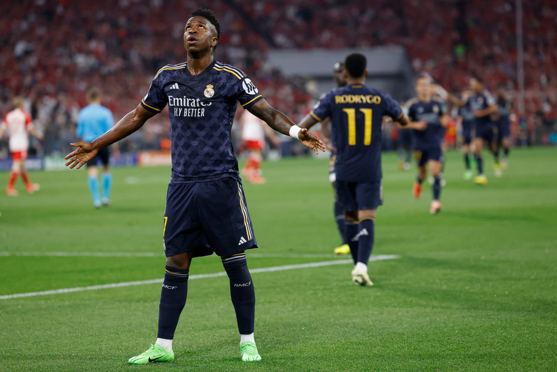 Real Madrid's Brazilian forward #07 Vinicius Junior celebrates scoring the opening goal with his teammates during the UEFA Champions League semi-final first leg football match between FC Bayern Munich and Real Madrid CF on April 30, 2024 in Munich, southern Germany. (Photo by Michaela STACHE / AFP) (Photo by MICHAELA STACHE/AFP via Getty Images)