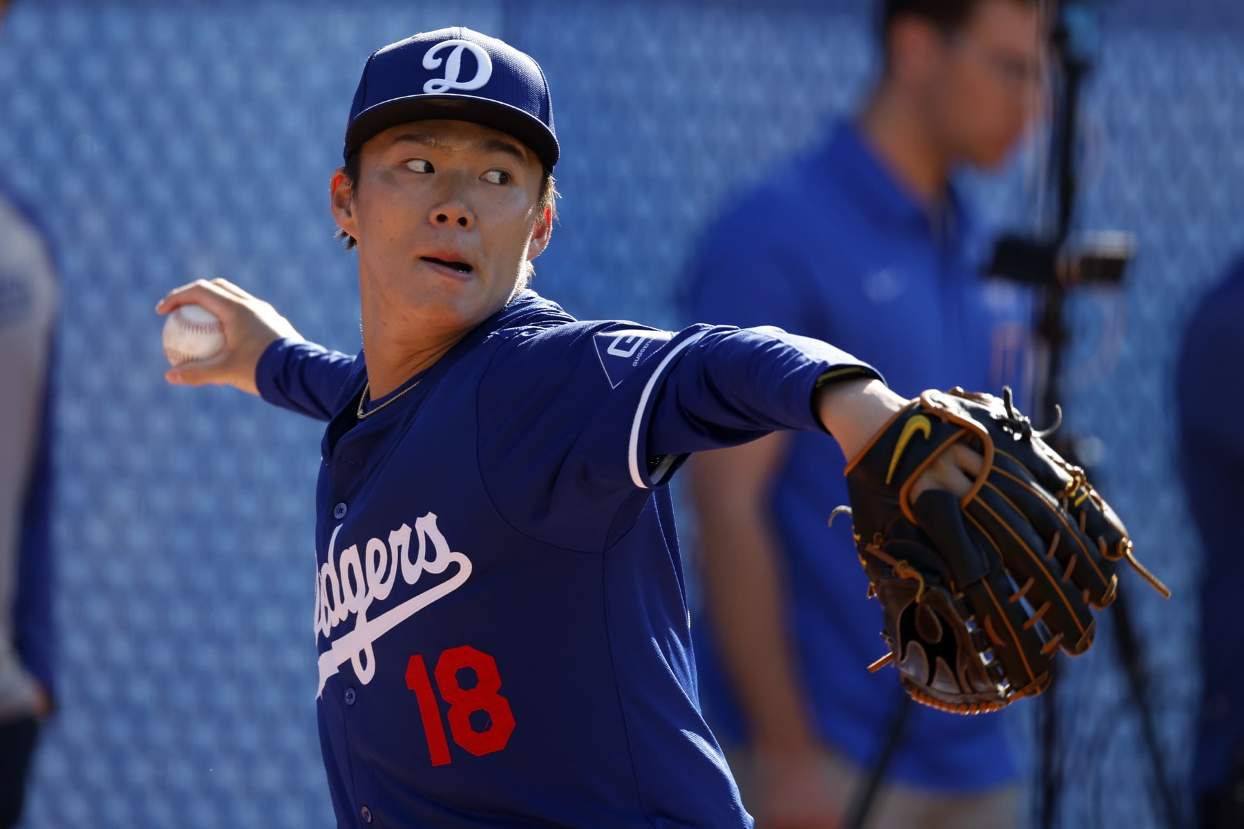 GLENDALE, ARIZONA - FEBRUARY 14: Yoshinobu Yamamoto #18 of the Los Angeles Dodgers pitches during workouts at Camelback Ranch on February 14, 2024 in Glendale, Arizona. (Photo by Chris Coduto/Getty Images)