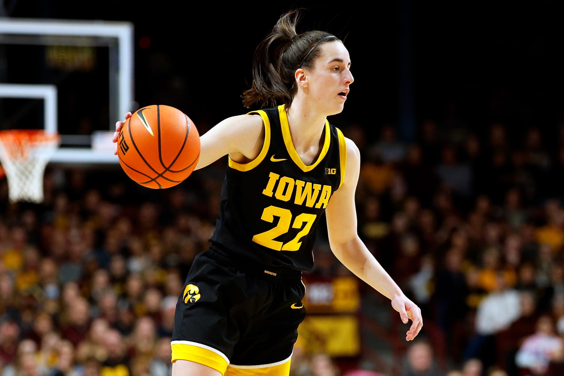 MINNEAPOLIS, MINNESOTA - FEBRUARY 28: Caitlin Clark #22 of the Iowa Hawkeyes dribbles the ball against the Minnesota Golden Gophers in the third quarter at Williams Arena on February 28, 2024 in Minneapolis, Minnesota. The Hawkeyes defeated the Golden Gophers 108-60. (Photo by David Berding/Getty Images)