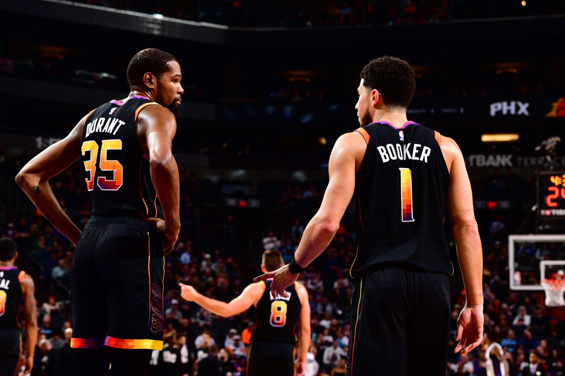 PHOENIX, AZ - January 16: Kevin Durant #35 of the Phoenix Suns and Devin Booker #1 of the Phoenix Suns talk during the game against the Sacramento Kings on January 16, 2024 at Footprint Center in Phoenix, Arizona. NOTE TO USER: User expressly acknowledges and agrees that, by downloading and or using this photograph, user is consenting to the terms and conditions of the Getty Images License Agreement. Mandatory Copyright Notice: Copyright 2024 NBAE (Photo by Barry Gossage/NBAE via Getty Images)