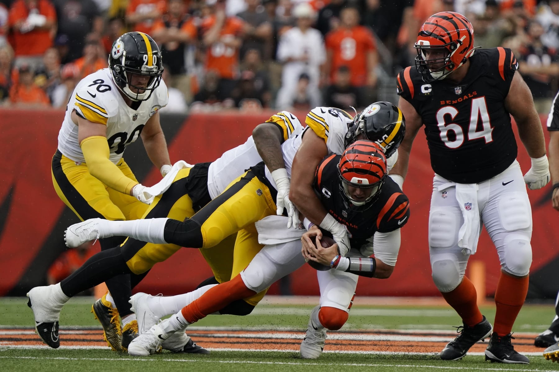 Pittsburgh Steelers linebacker Alex Highsmith,top center, sacks Cincinnati Bengals quarterback Joe Burrow, bottom center, during the first half of an NFL football game, Sunday, Sept. 11, 2022, in Cincinnati. (AP Photo/Joshua A. Bickel)