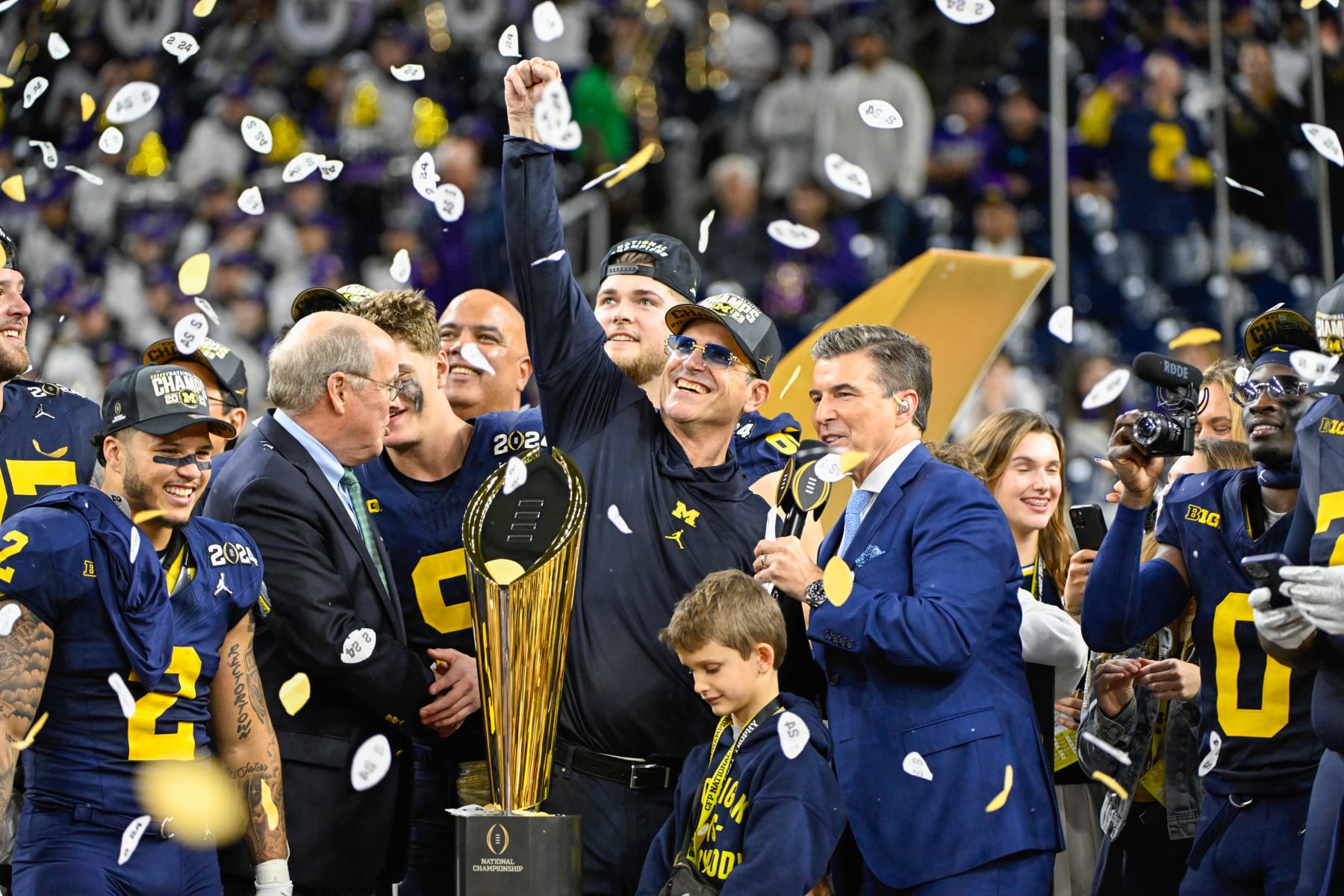 HOUSTON, TX - JANUARY 08: Michigan Wolverines head coach Jim Harbaugh acknowledges the crowd during the trophy presentation following the CFP National Championship football game between the Washington Huskies and Michigan Wolverines at NRG Stadium on January 8, 2024 in Houston, Texas. (Photo by Ken Murray/Icon Sportswire via Getty Images)