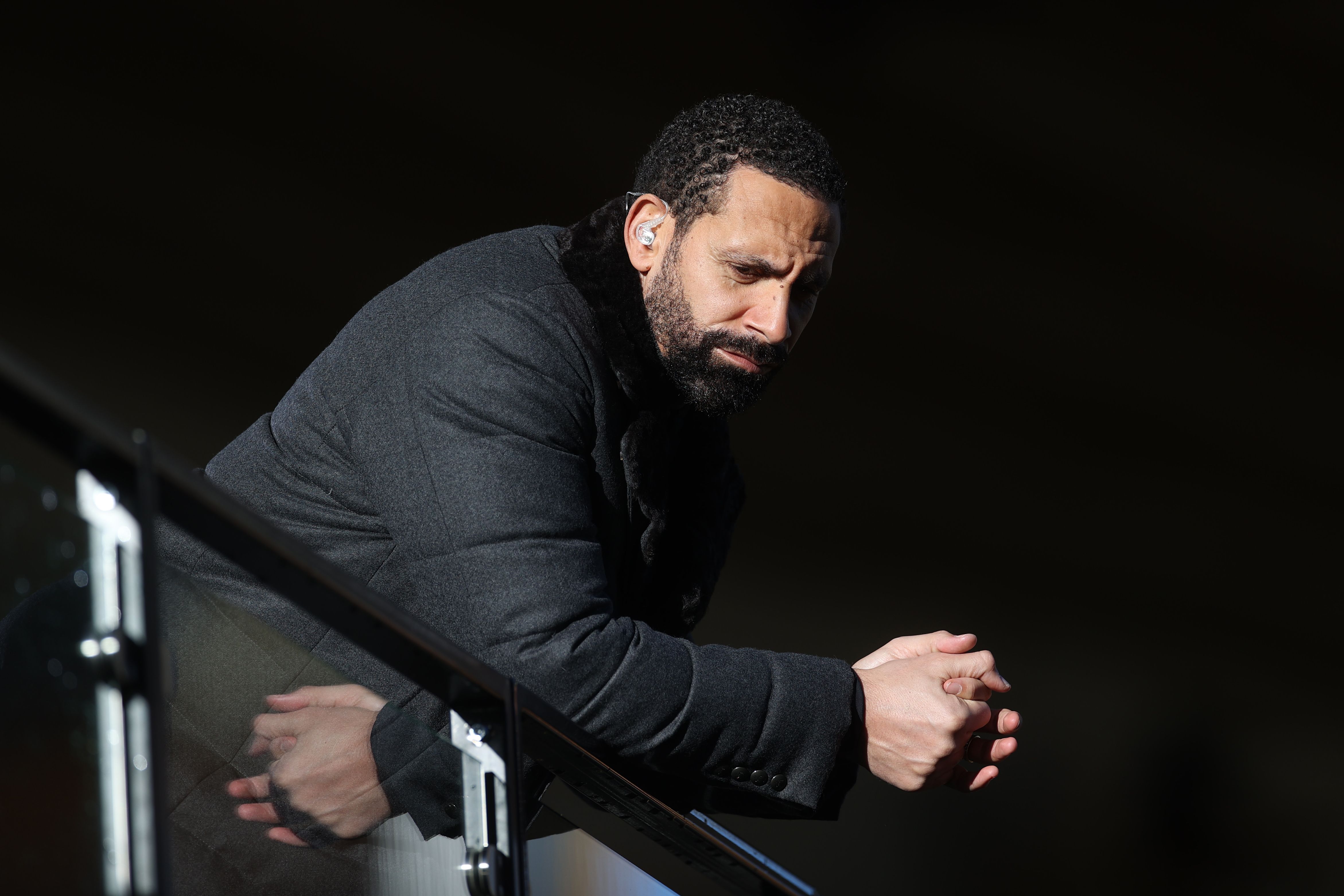 Former English footballer and BT Sport's television pundit Rio Ferdinand looks on before the English Premier League football match between Wolverhampton Wanderers and West Bromwich Albion at the Molineux stadium in Wolverhampton, central England on January 16, 2021. (Photo by CARL RECINE / POOL / AFP) / RESTRICTED TO EDITORIAL USE. No use with unauthorized audio, video, data, fixture lists, club/league logos or 'live' services. Online in-match use limited to 120 images. An additional 40 images may be used in extra time. No video emulation. Social media in-match use limited to 120 images. An additional 40 images may be used in extra time. No use in betting publications, games or single club/league/player publications. /  (Photo by CARL RECINE/POOL/AFP via Getty Images)