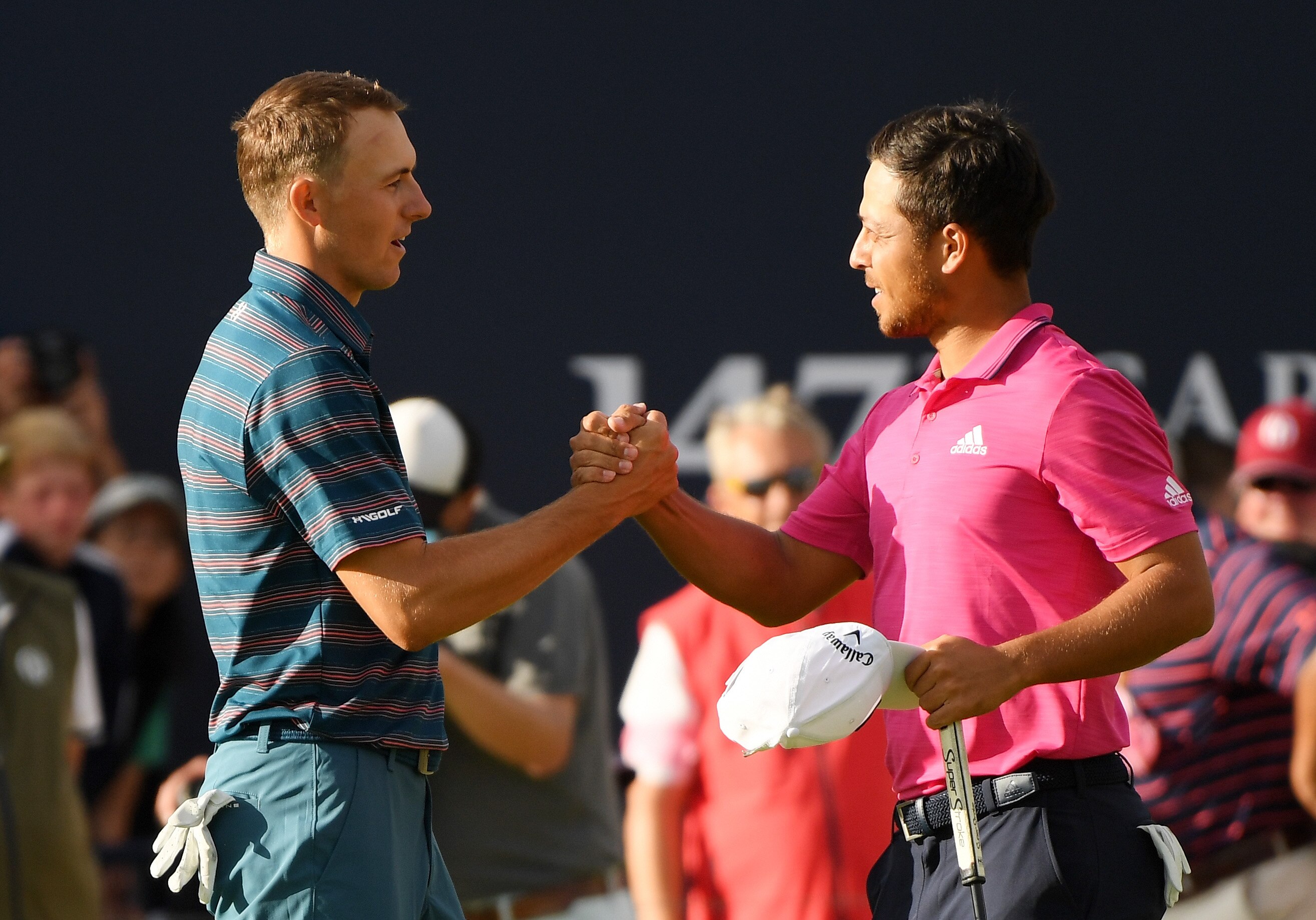 CARNOUSTIE, SCOTLAND - JULY 22:  Xander Schauffele of the United States shakes hands with Jordan Spieth of the United States on the 18th green during the final round of the 147th Open Championship at Carnoustie Golf Club on July 22, 2018 in Carnoustie, Scotland.  (Photo by Harry How/Getty Images)