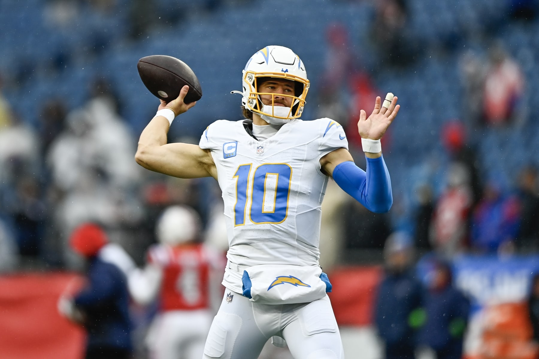 FOXBOROUGH, MASSACHUSETTS - DECEMBER 03: Justin Herbert #10 of the Los Angeles Chargers warms up before the game against the New England Patriots at Gillette Stadium on December 03, 2023 in Foxborough, Massachusetts. (Photo by Billie Weiss/Getty Images)