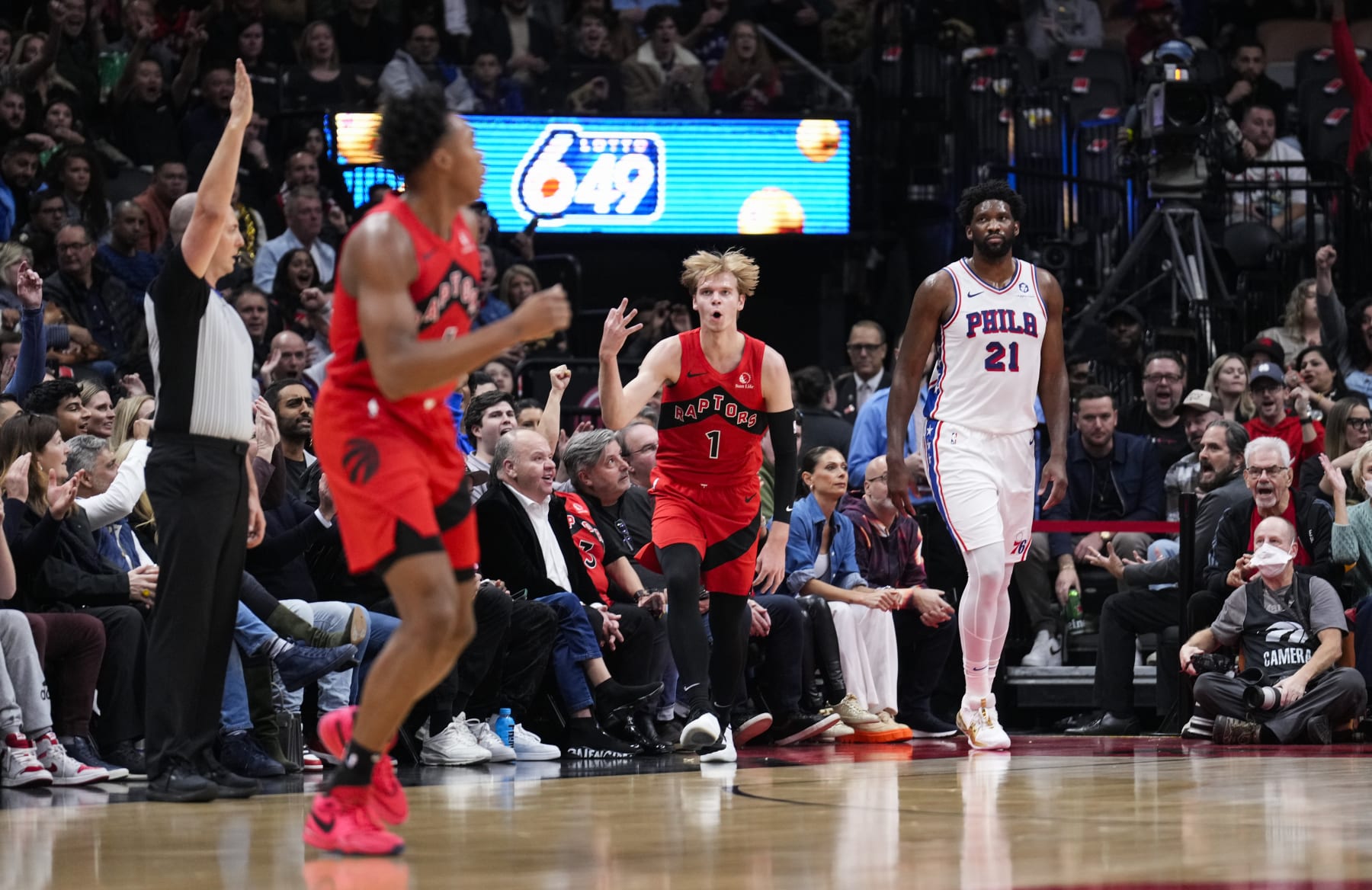 TORONTO, ON - OCTOBER 28: Gradey Dick #1 of Toronto Raptors celebrates a three point shot beside Joel Embiid #21 of the Philadelphia 76ers during first half of their basketball game at the Scotiabank Arena on October 28, 2023 in Toronto, Ontario, Canada. NOTE TO USER: User expressly acknowledges and agrees that, by downloading and/or using this Photograph, user is consenting to the terms and conditions of the Getty Images License Agreement. (Photo by Mark Blinch/Getty Images)