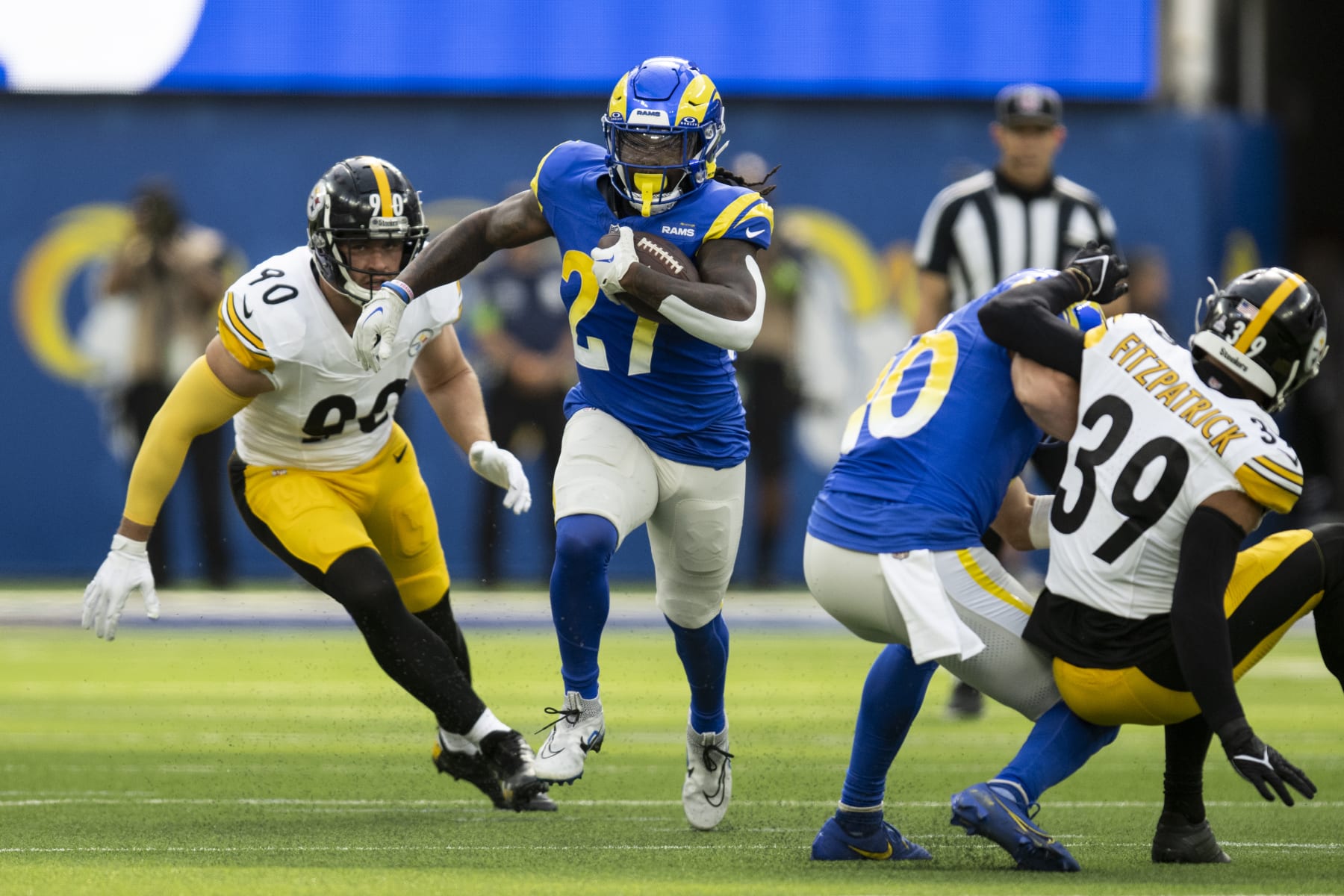 Los Angeles Rams running back Darrell Henderson Jr. (27) runs with the ball past Pittsburgh Steelers linebacker T.J. Watt (90) during an NFL football game, Sunday, Oct. 22, 2023, in Inglewood, Calif. (AP Photo/Kyusung Gong)