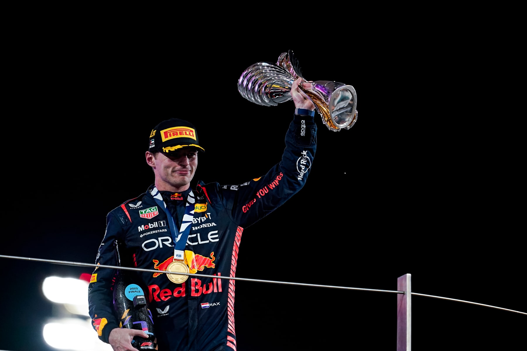 ABU DHABI, UNITED ARAB EMIRATES - NOVEMBER 26: Max Verstappen of Netherlands and Oracle Red Bull Racing celebrates on the podium during the F1 Grand Prix of Abu Dhabi at Yas Marina Circuit on November 26, 2023 in Abu Dhabi, United Arab Emirates. (Photo by James Gasperotti/Ciancaphoto Studio/Getty Images)