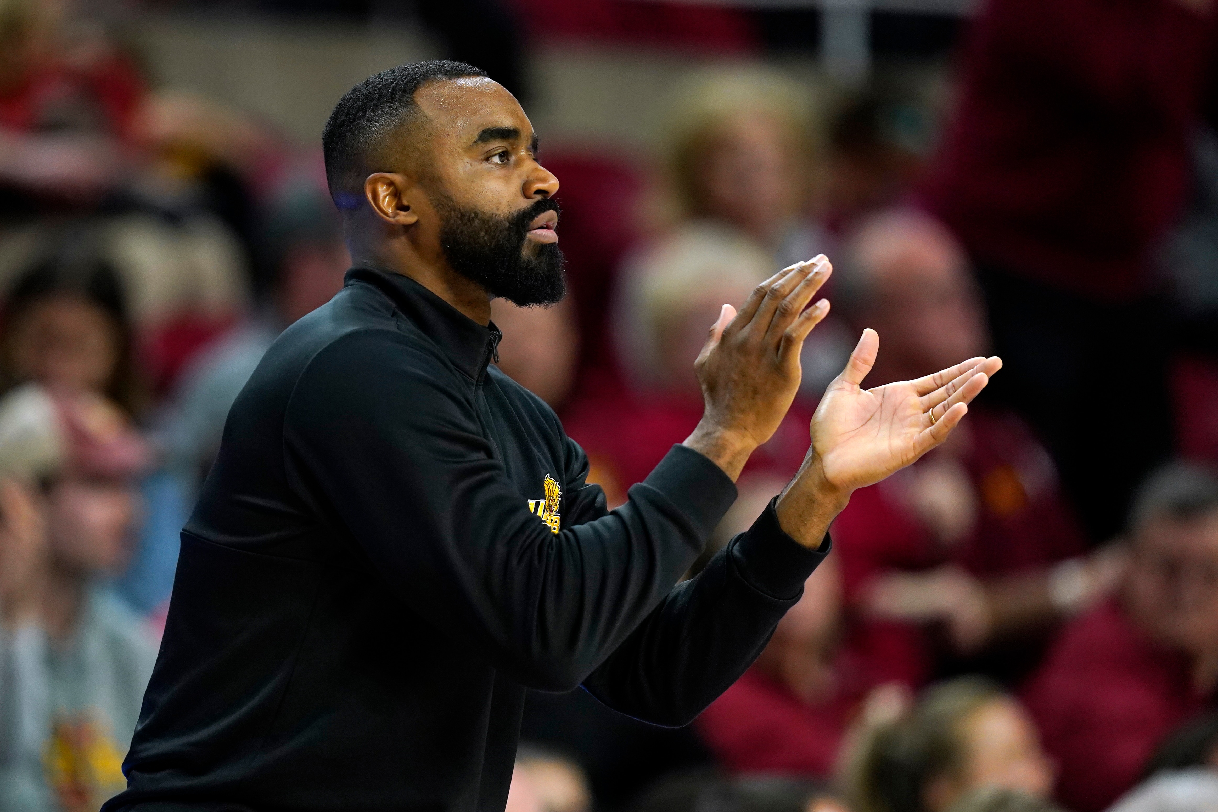 Arkansas-Pine Bluff head coach Solomon Bozeman applauds his team during the first half of an NCAA college basketball game against Iowa State, Wednesday, Dec. 1, 2021, in Ames, Iowa. (AP Photo/Charlie Neibergall)