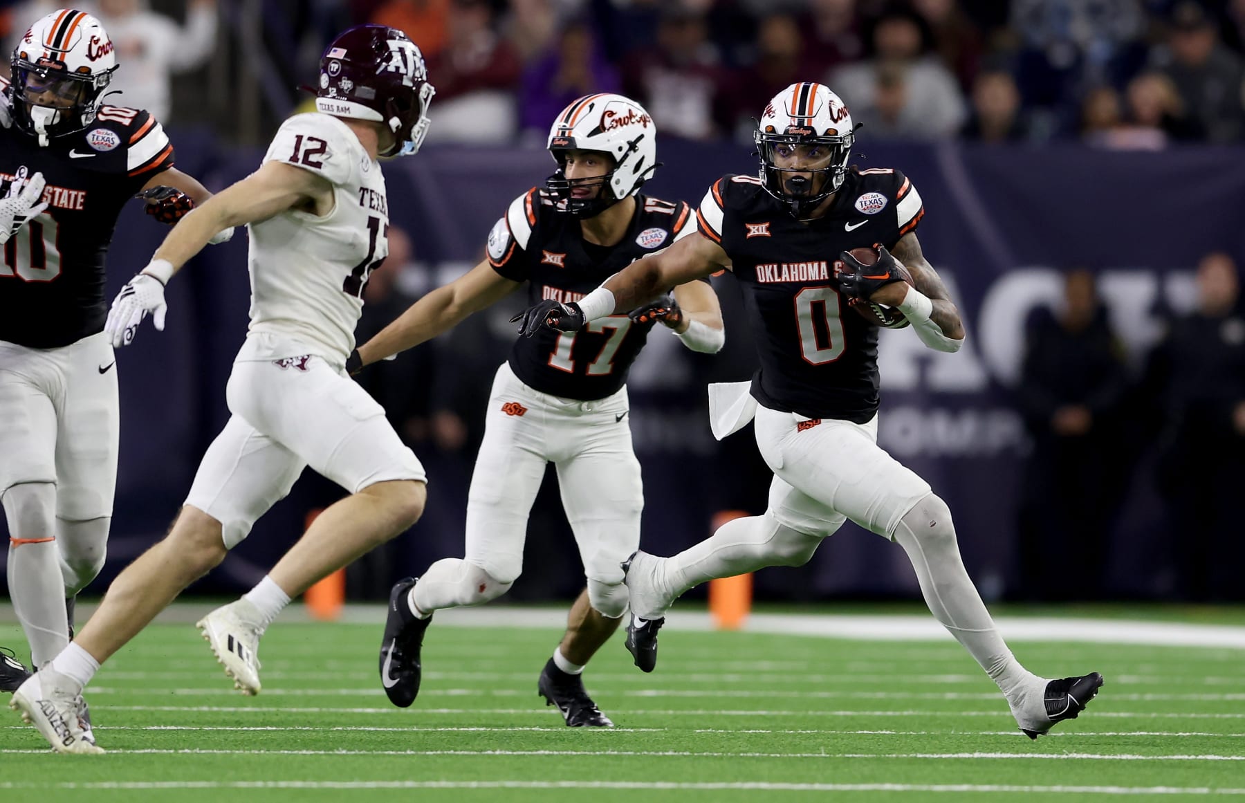 HOUSTON, TEXAS - DECEMBER 27: Ollie Gordon II #0 of the Oklahoma State Cowboys runs the ball in the fourth quarter against the Texas A&M Aggies during the TaxAct Texas Bowl at NRG Stadium on December 27, 2023 in Houston, Texas. (Photo by Tim Warner/Getty Images)