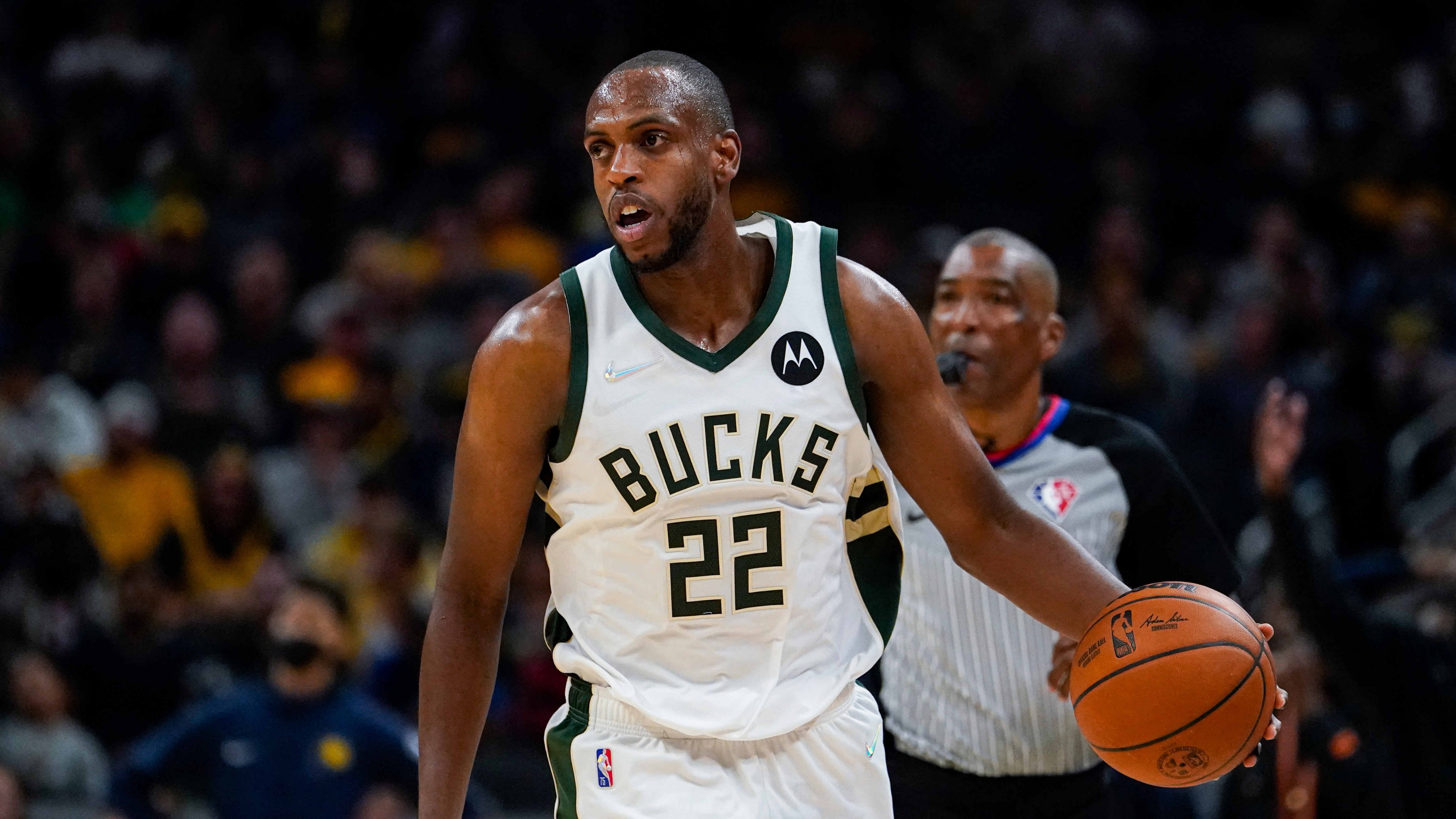 Milwaukee Bucks forward Khris Middleton (22) plays against the Indiana Pacers during the second half of an NBA basketball game in Indianapolis, Monday, Oct. 25, 2021. The Bucks defeated the Pacers 119-109. (AP Photo/Michael Conroy)