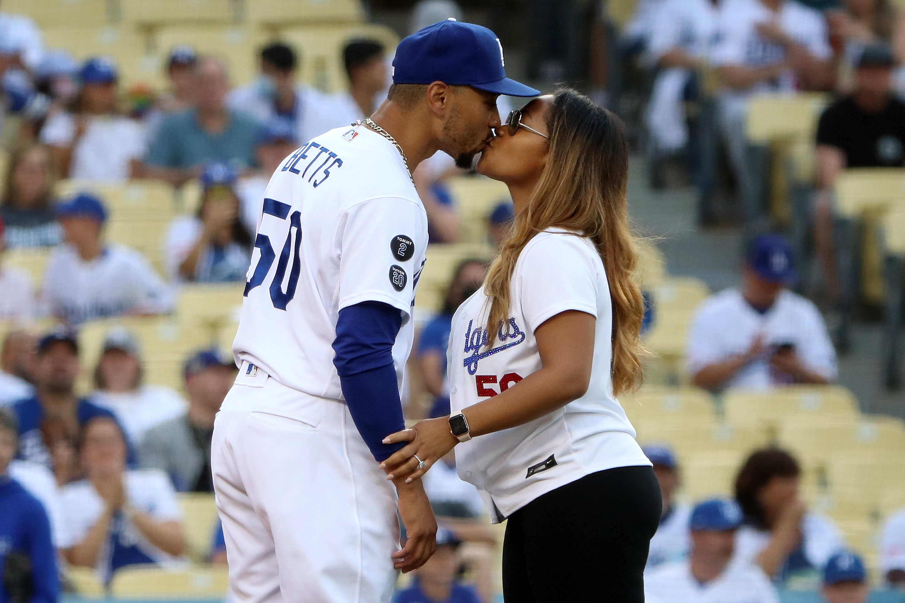 LOS ANGELES, CALIFORNIA - JUNE 16: Mookie Betts #50 of the Los Angeles Dodgers kisses his fiance Brianna Hammonds before the game against the Philadelphia Phillies at Dodger Stadium on June 16, 2021 in Los Angeles, California. (Photo by Katelyn Mulcahy/Getty Images)